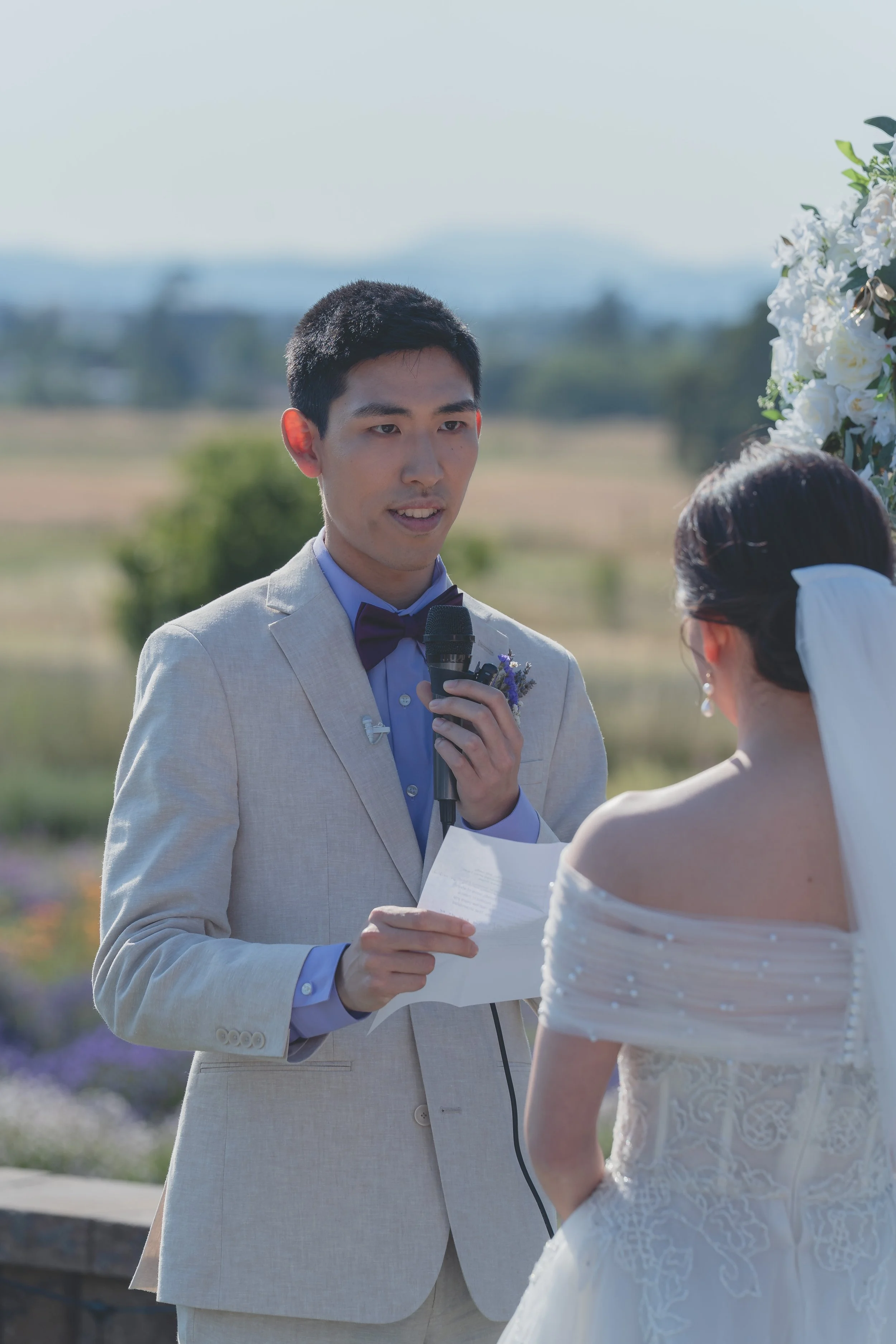 Groom speaking during the ceremony with the Sonoma landscape behind him.