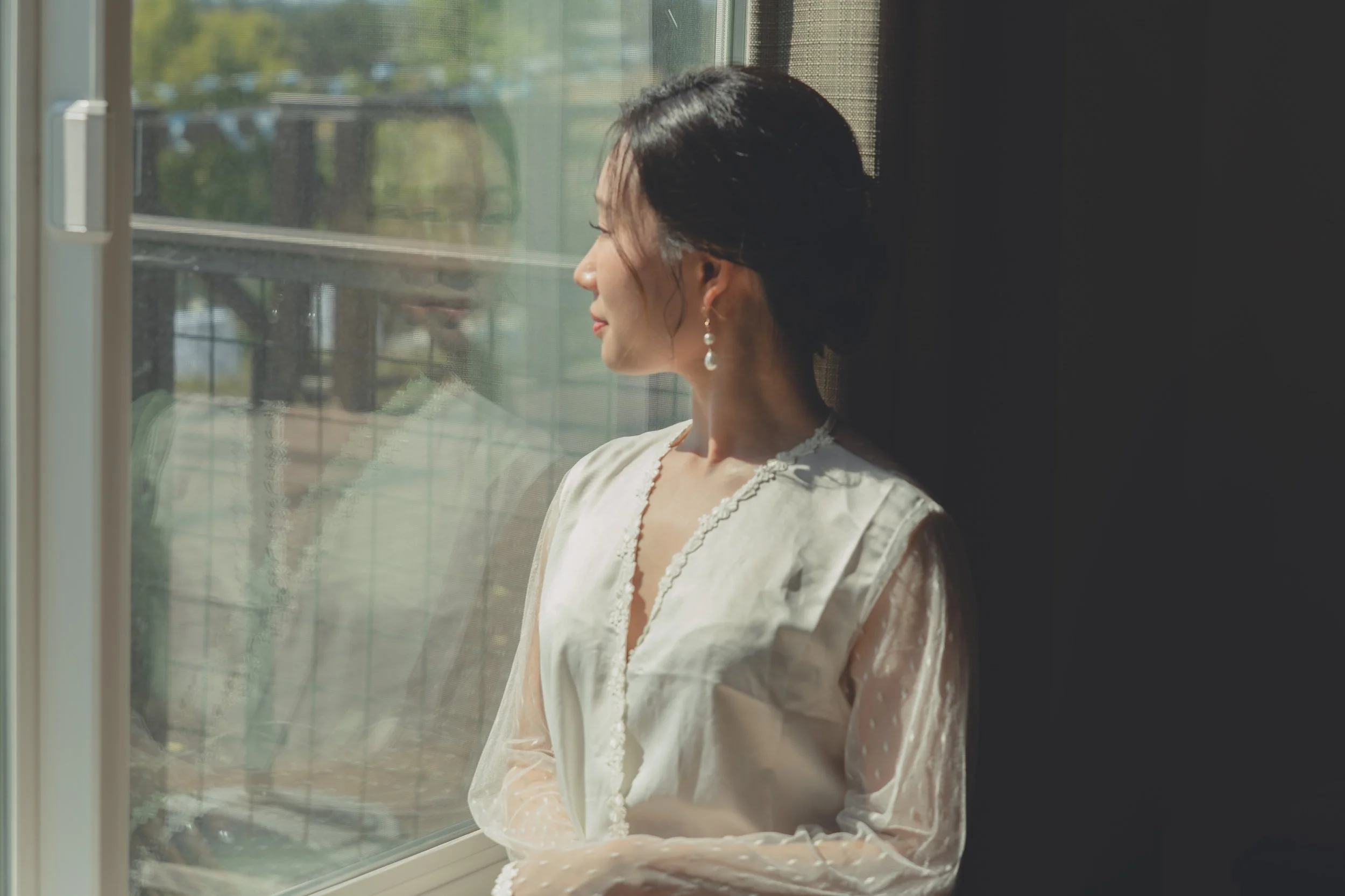 Bride photographed in soft window light during a quiet moment at a Sonoma wedding.
