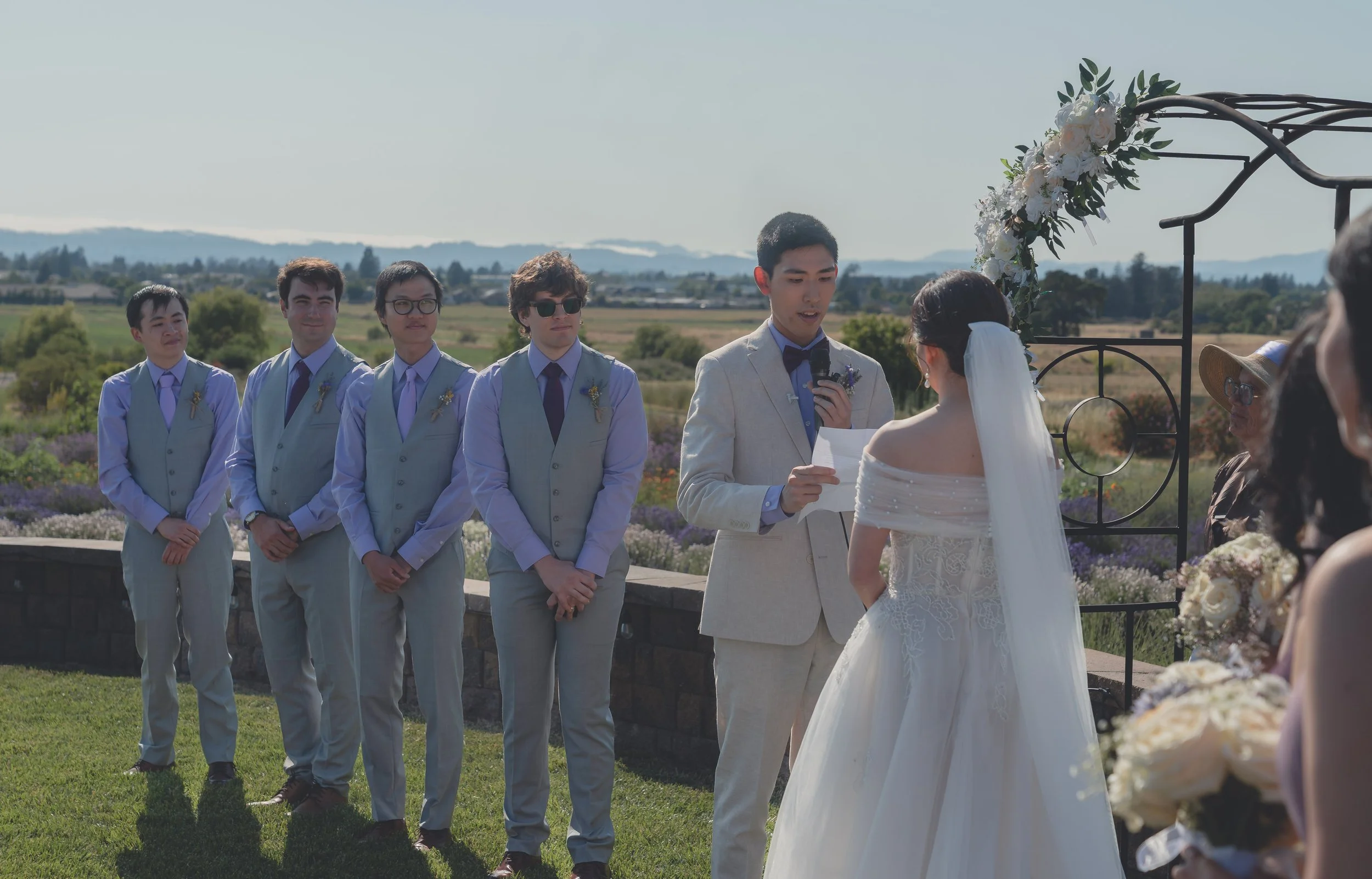 Bride and groom standing together as the ceremony progresses in Sonoma.