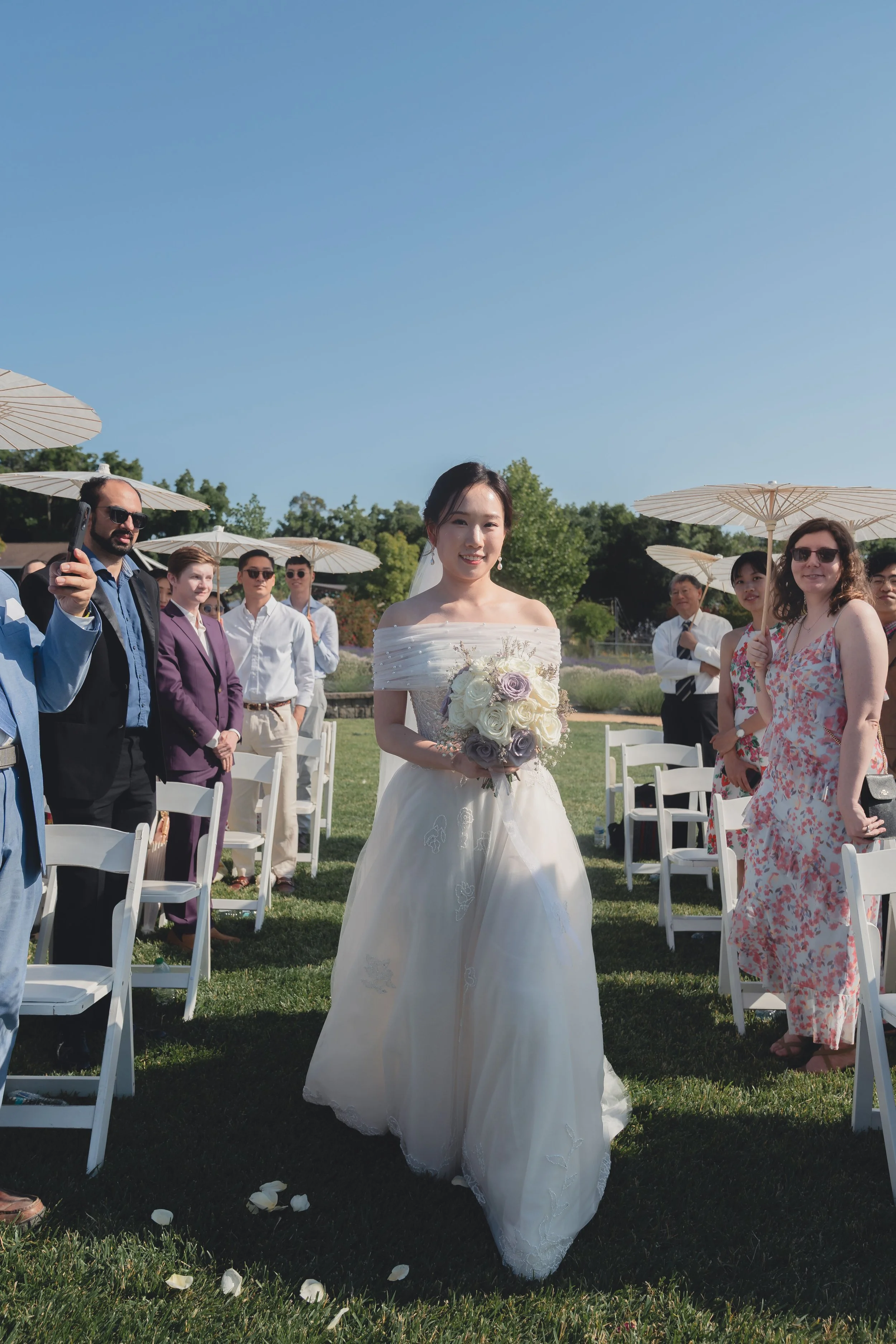 Bride nearing the ceremony arch during Katherine and Calvin’s Sonoma wedding.