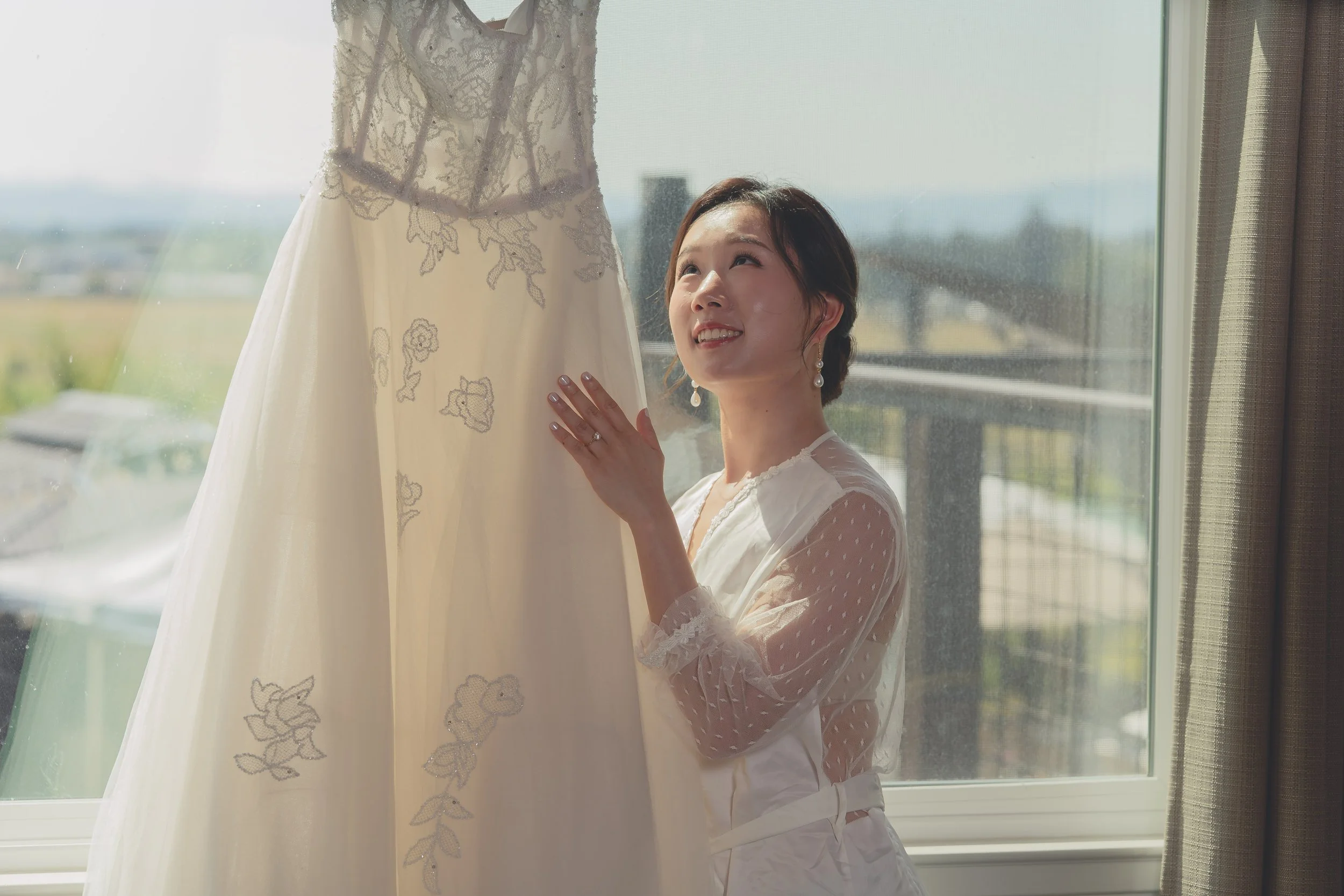 Bride standing near her wedding dress, captured with a timeless, documentary approach in Sonoma.