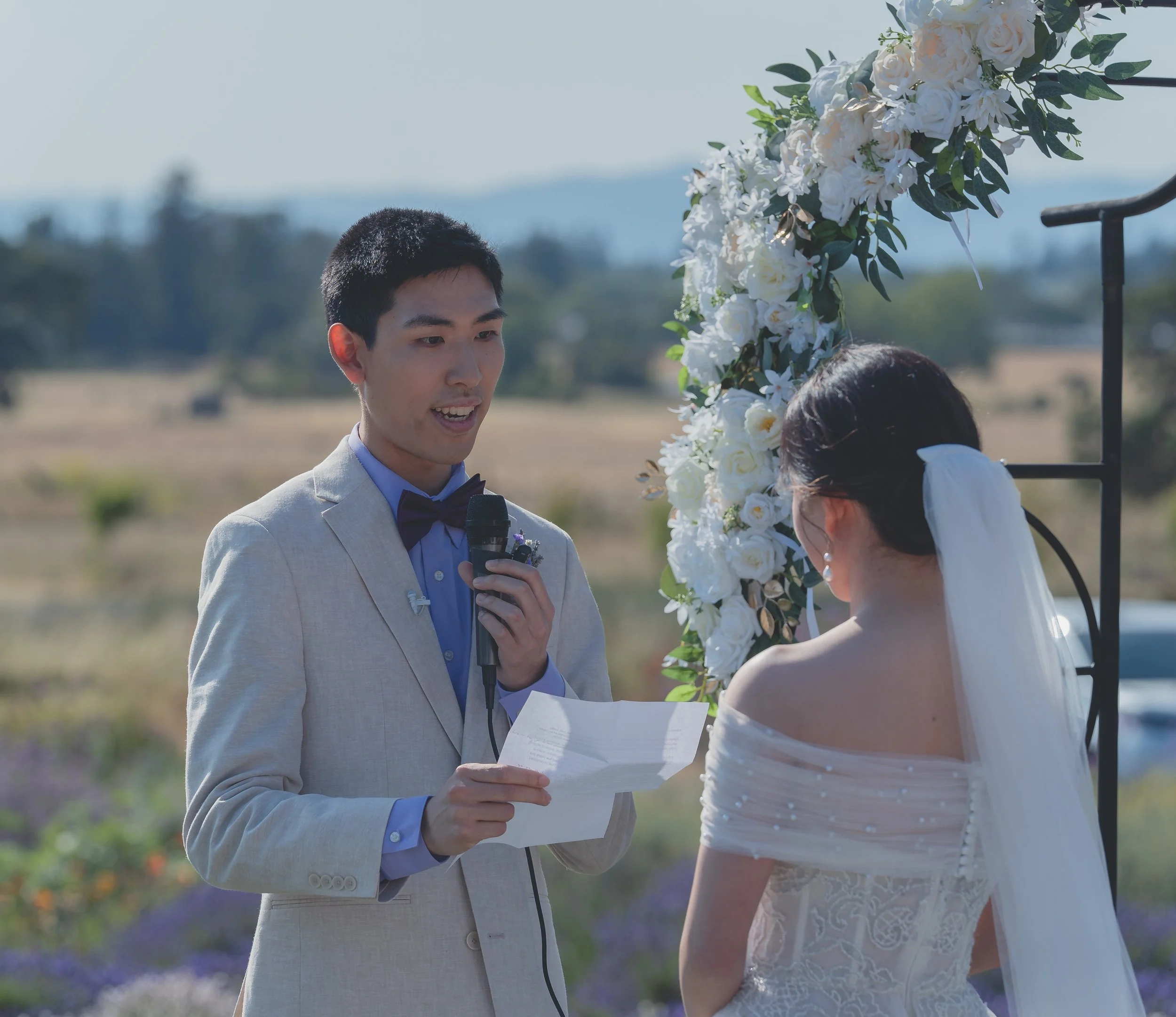 Bride and groom sharing an intimate moment during the vows in Sonoma.