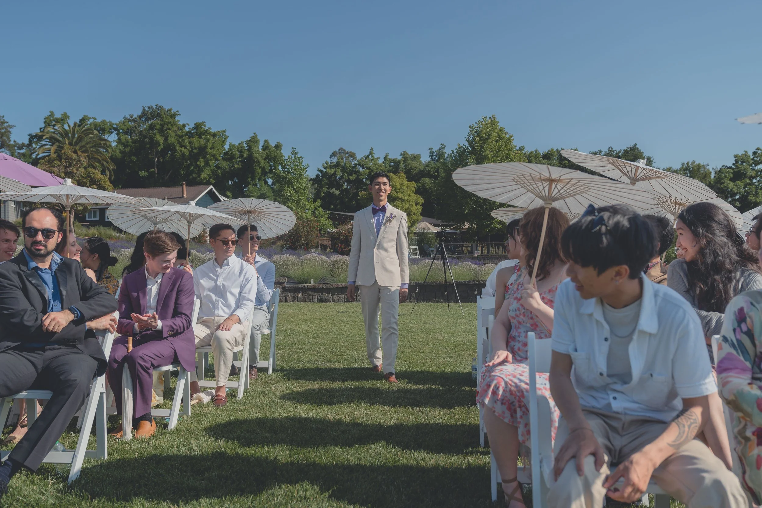 Groom and groomsmen walking together toward the ceremony during a Sonoma wedding.