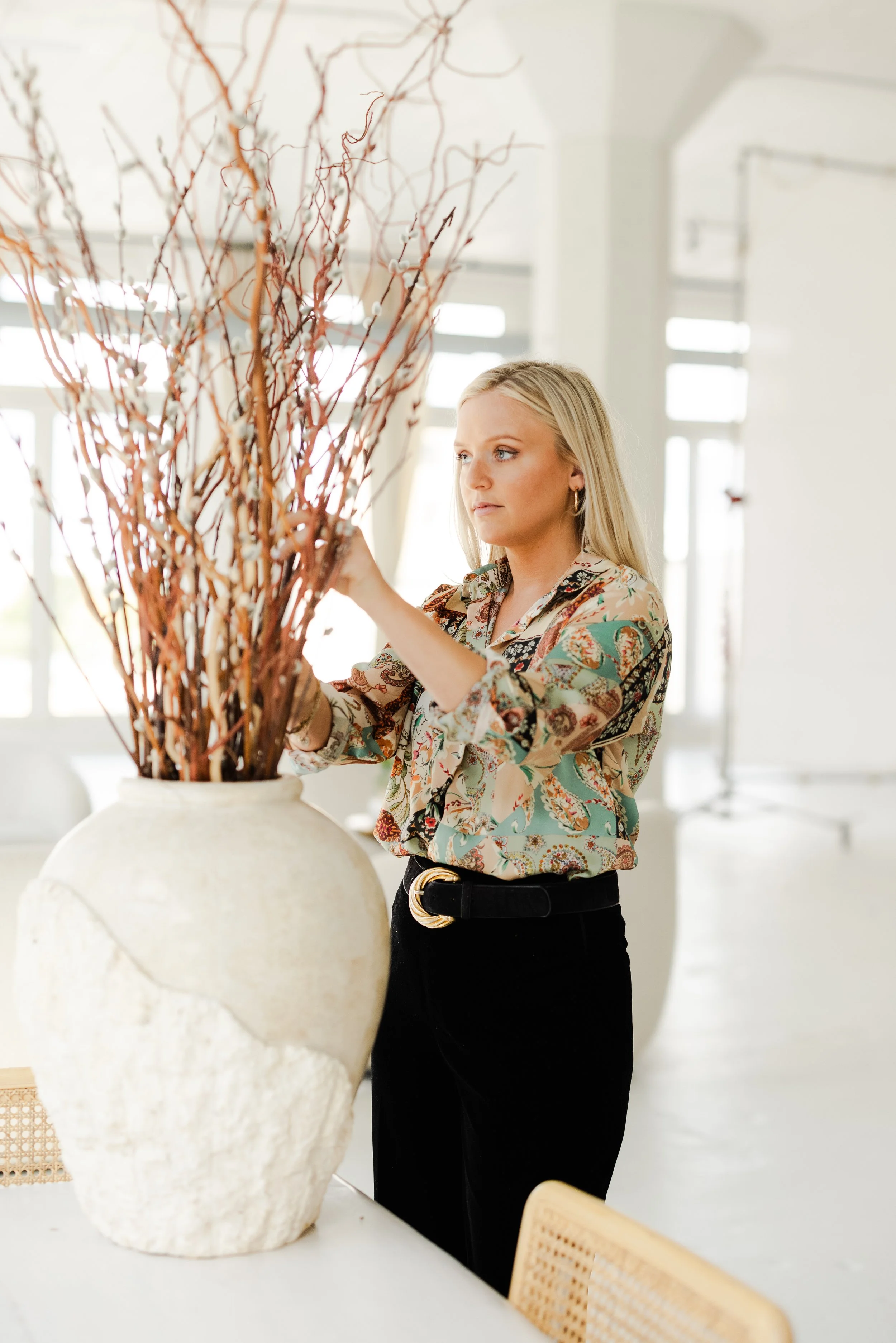 Interior designer near me arranging cute and high end luxury decor in a home in Naperville, IL