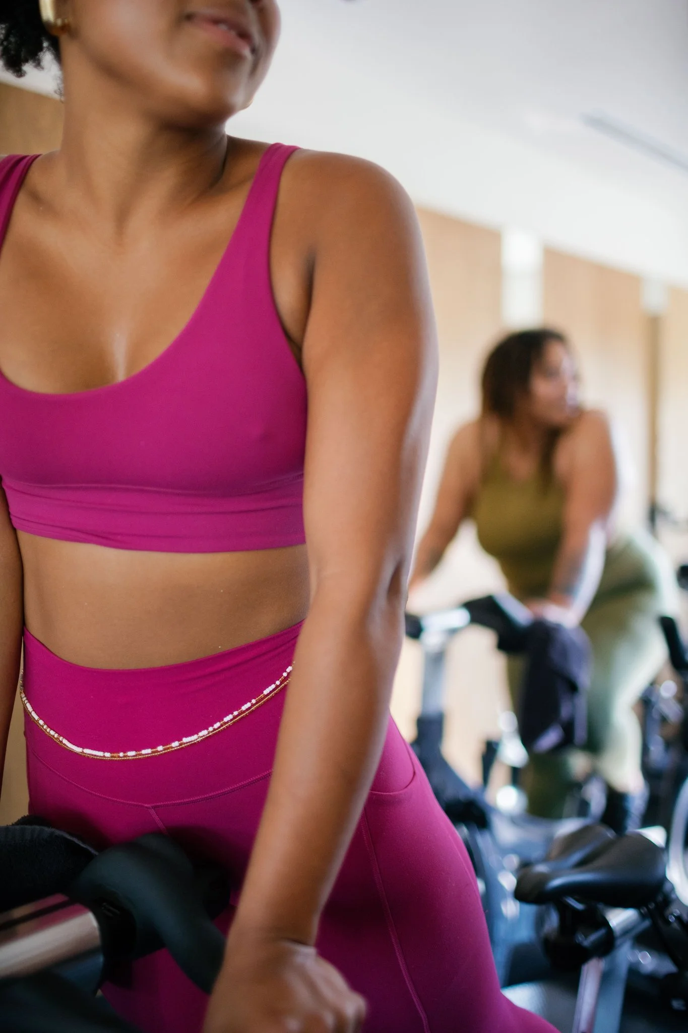 Riders on spin bikes during a Cycle 60 class at The Drop In