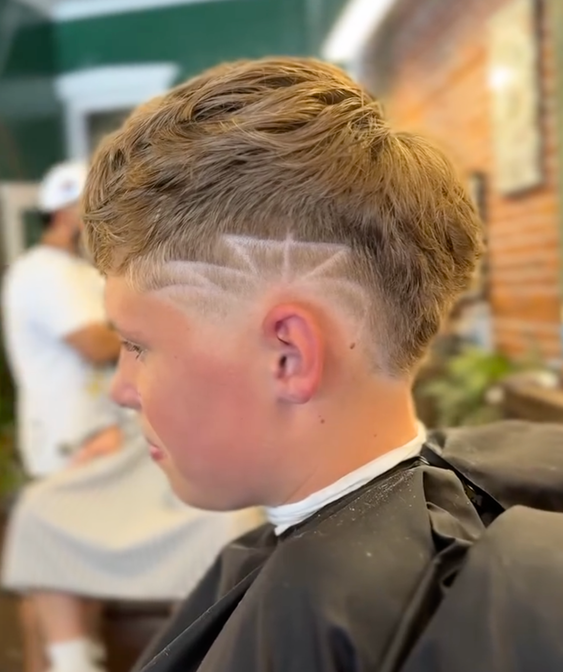 Kids fade haircut with custom linework design at Rebellion Barbershop Victoria.