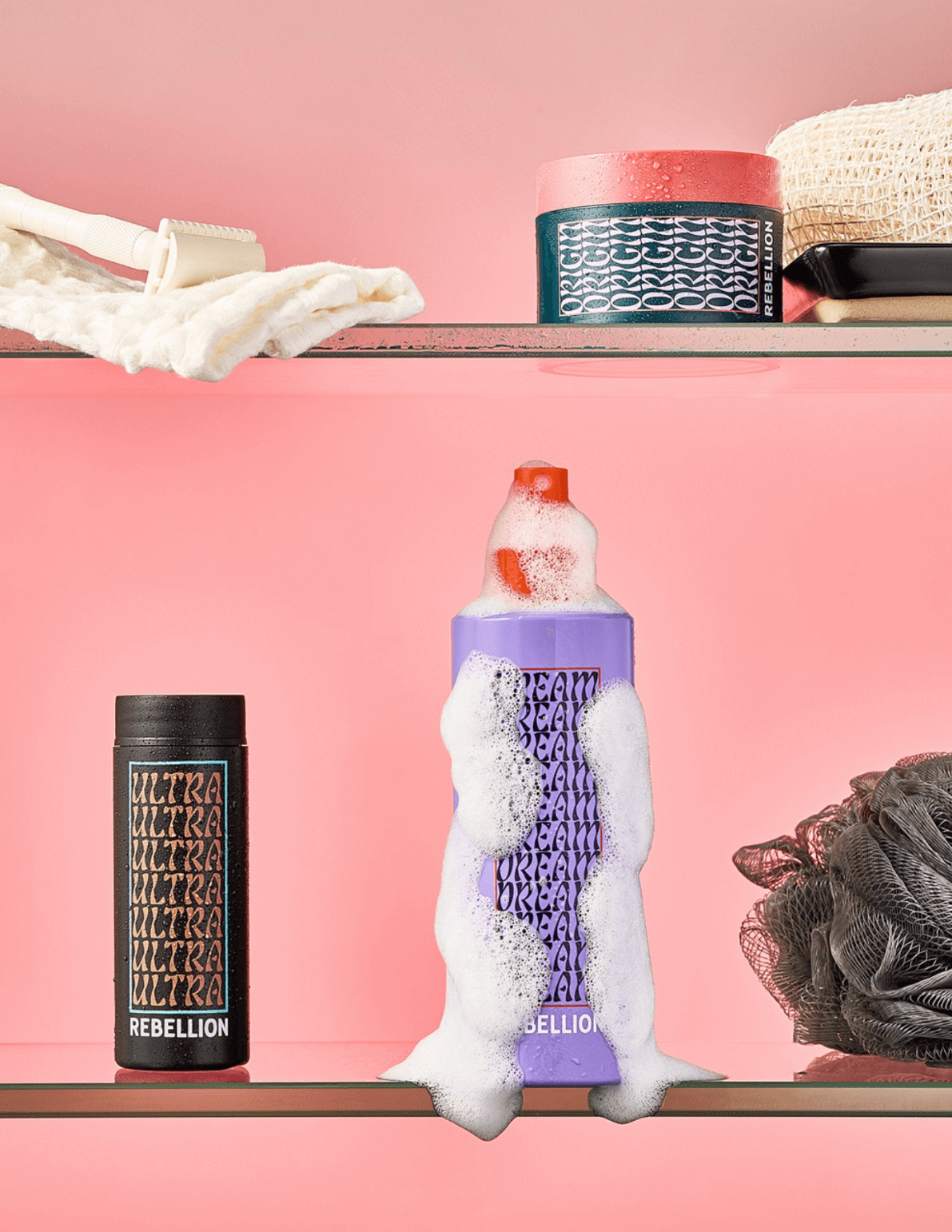 Rebellion Dream and Ultra hair products displayed on pink background with soap foam for wholesale promotion.