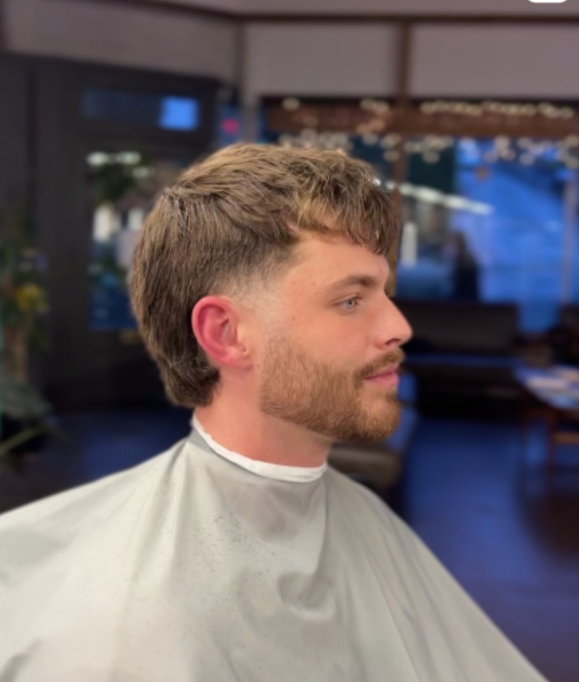 Men’s textured crop with messy top and tapered sides at Rebellion Barbershop