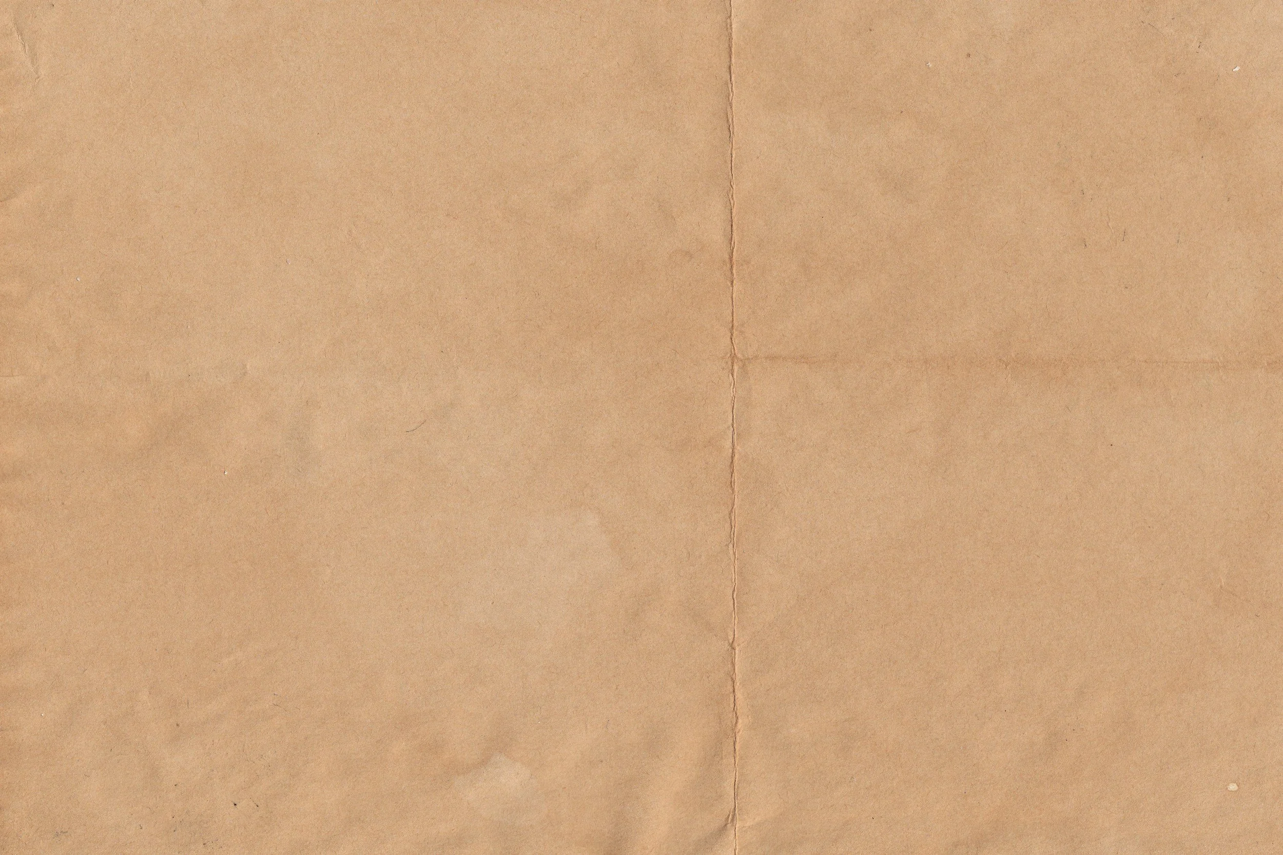 A close-up image of brown textured paper, possibly a cardboard or kraft paper surface.
