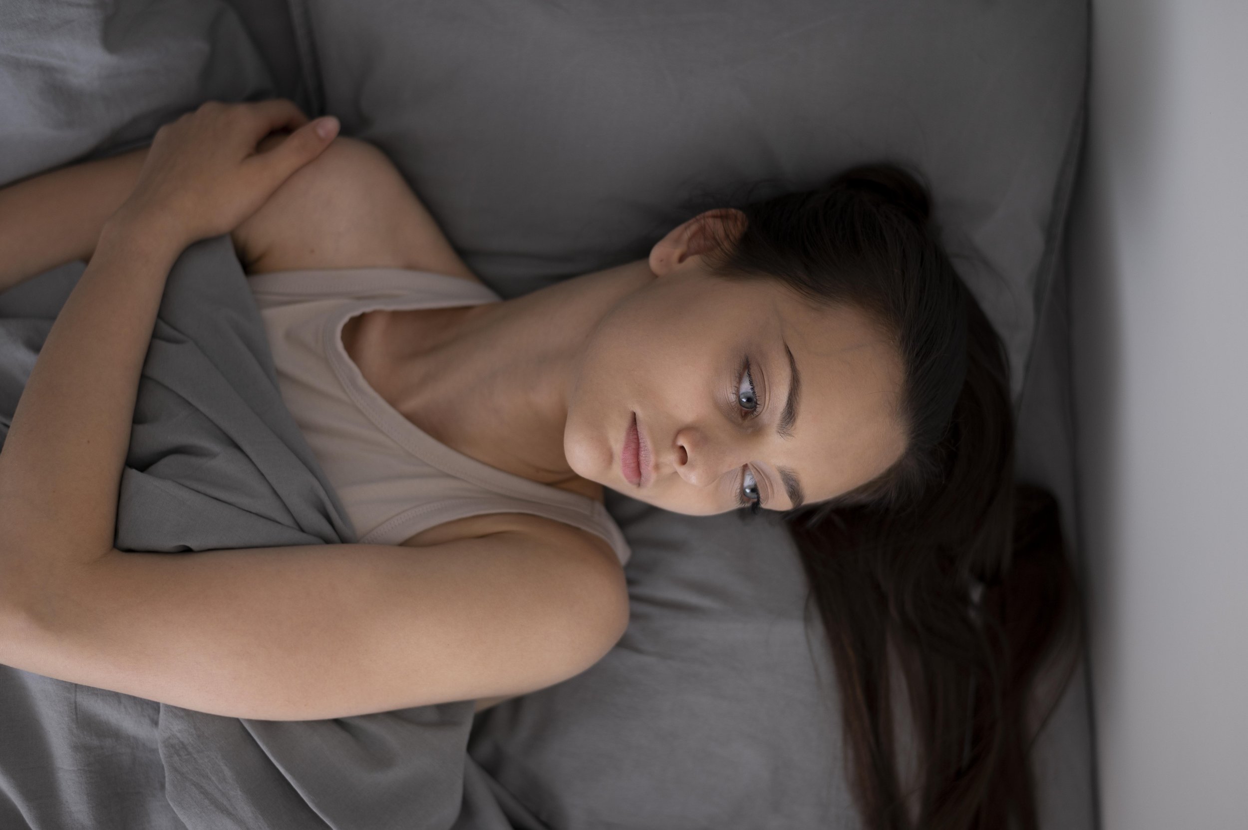 Person overwhelmed by unfinished tasks and constant mental clutter related to ADHD.