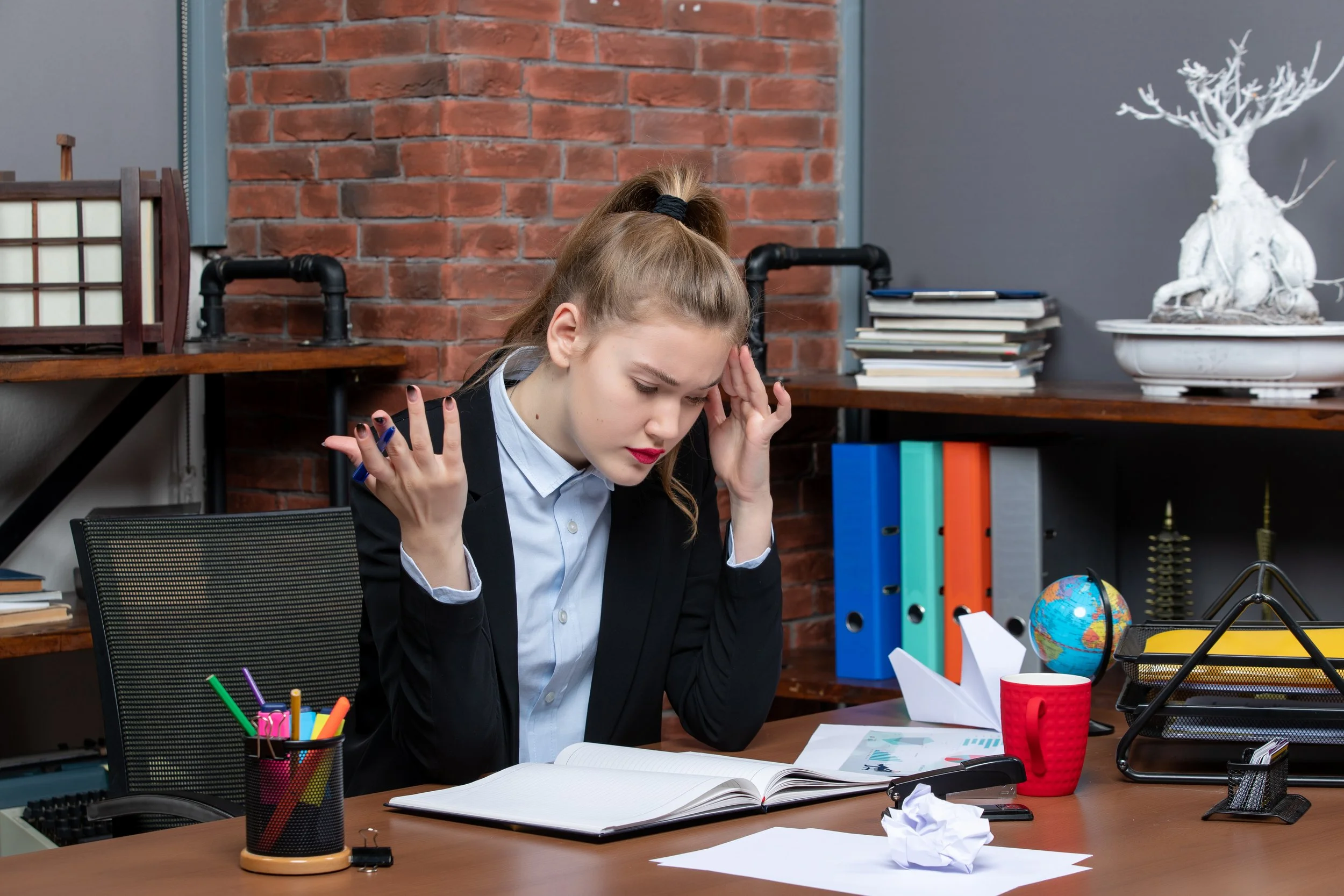 Person experiencing burnout symptoms while trying to manage work and personal responsibilities.