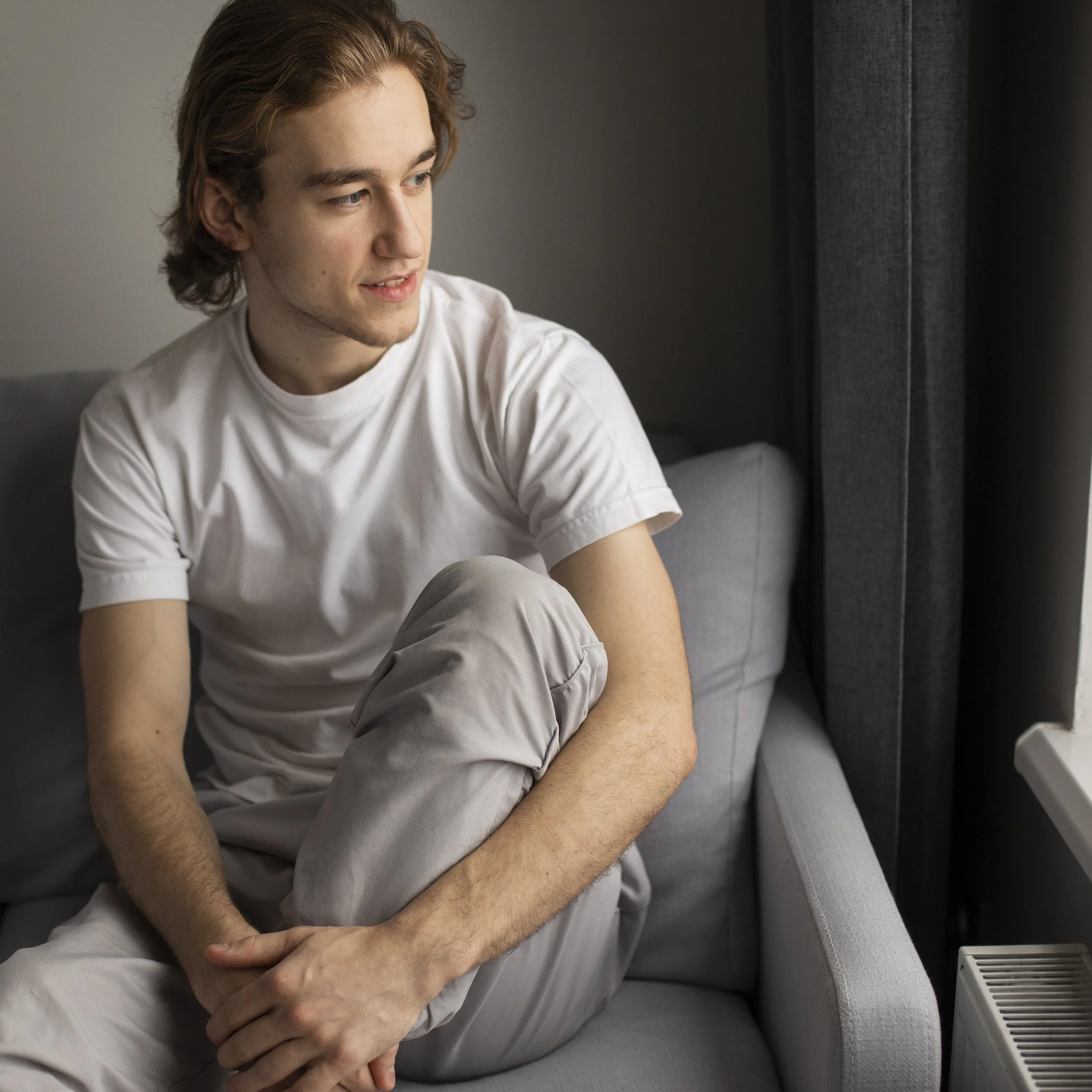 “Man sitting quietly with stress and emotional weight, highlighting the need for mental health support for men.”