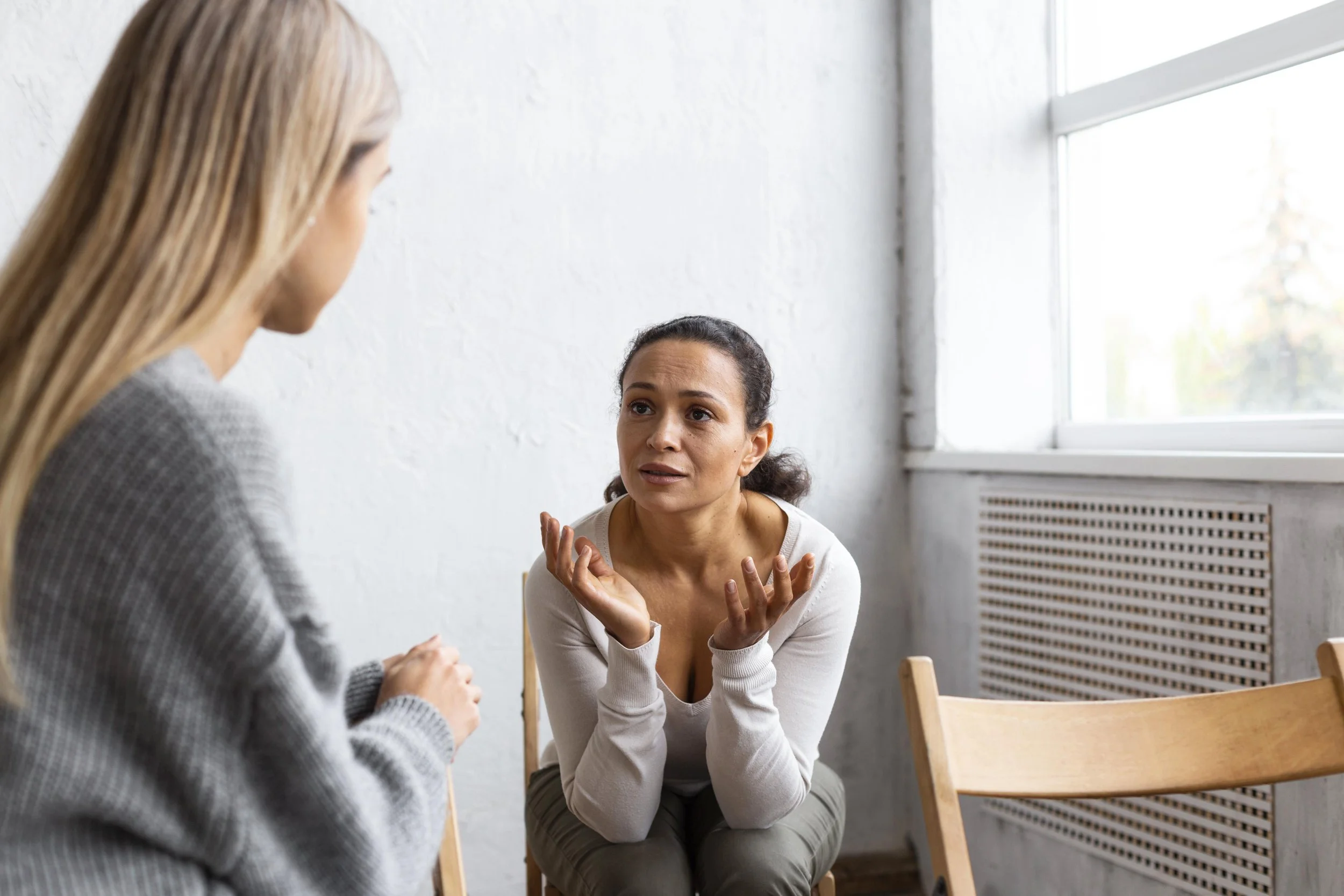 Client discussing anger triggers and reactions with therapist during counseling session.