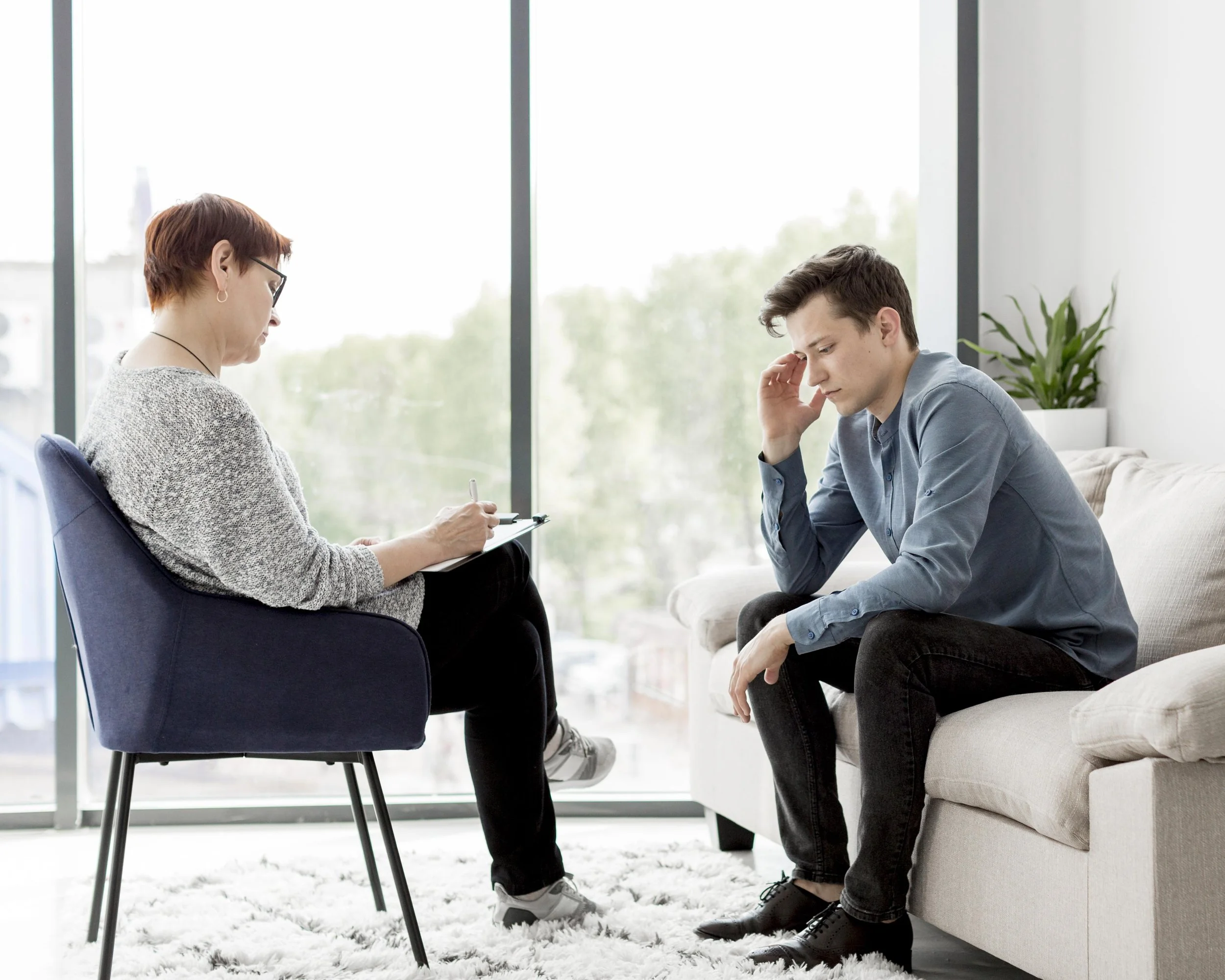 Person opening up about emotional struggles during a depression therapy session.