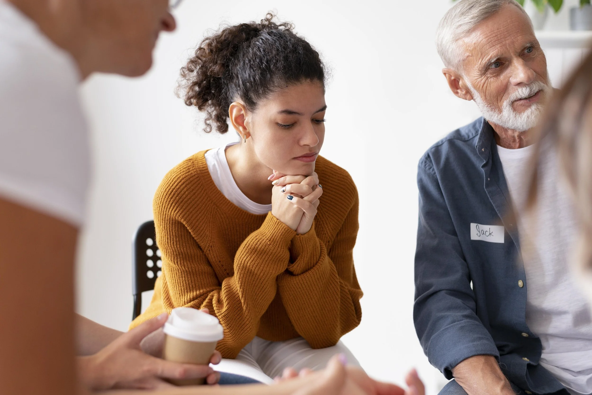 Individual in a quiet moment of reflection while navigating emotional wellbeing.