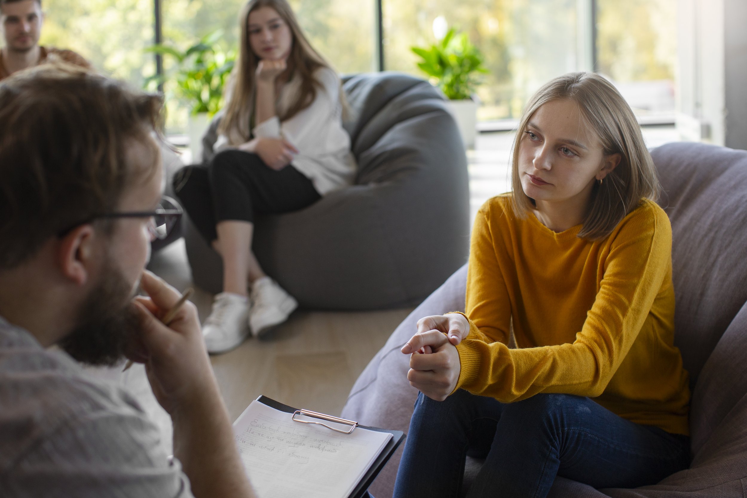 Client discussing alcohol use and emotional health concerns with therapist during counseling session.