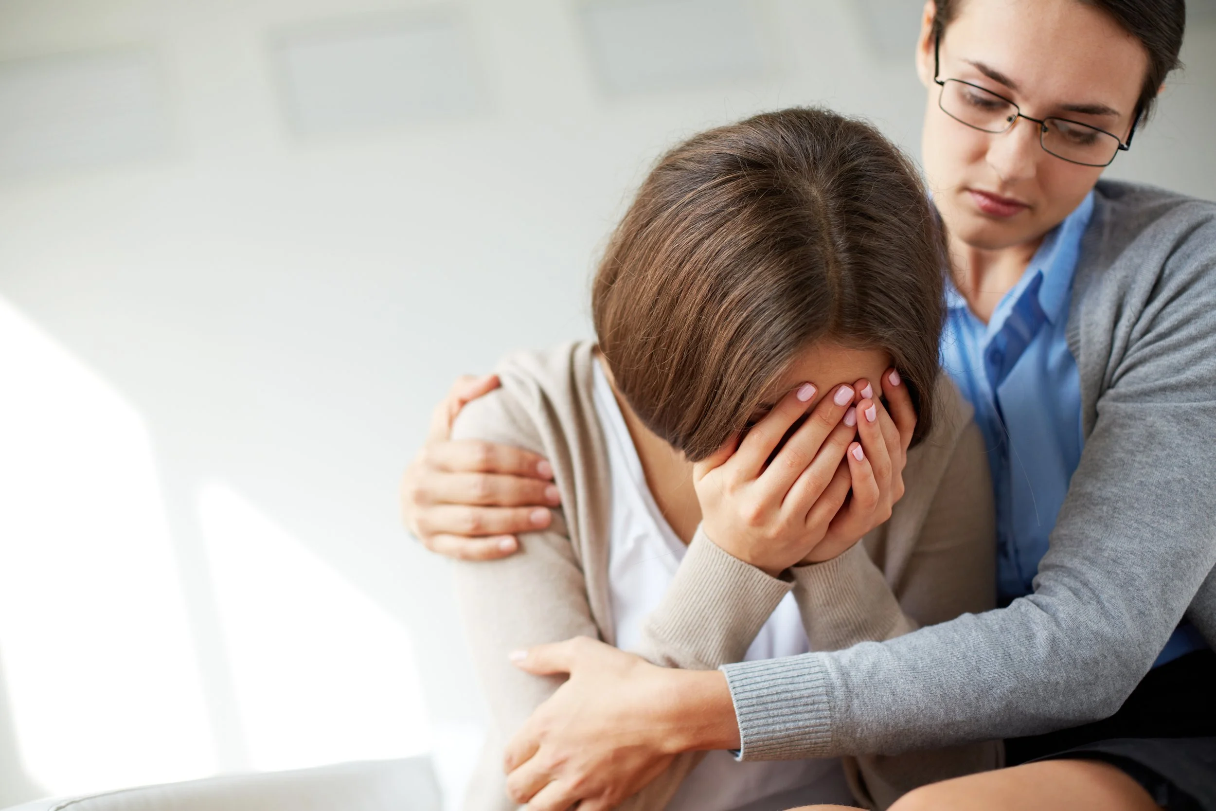 Client speaking with therapist about depression symptoms and emotional wellbeing.