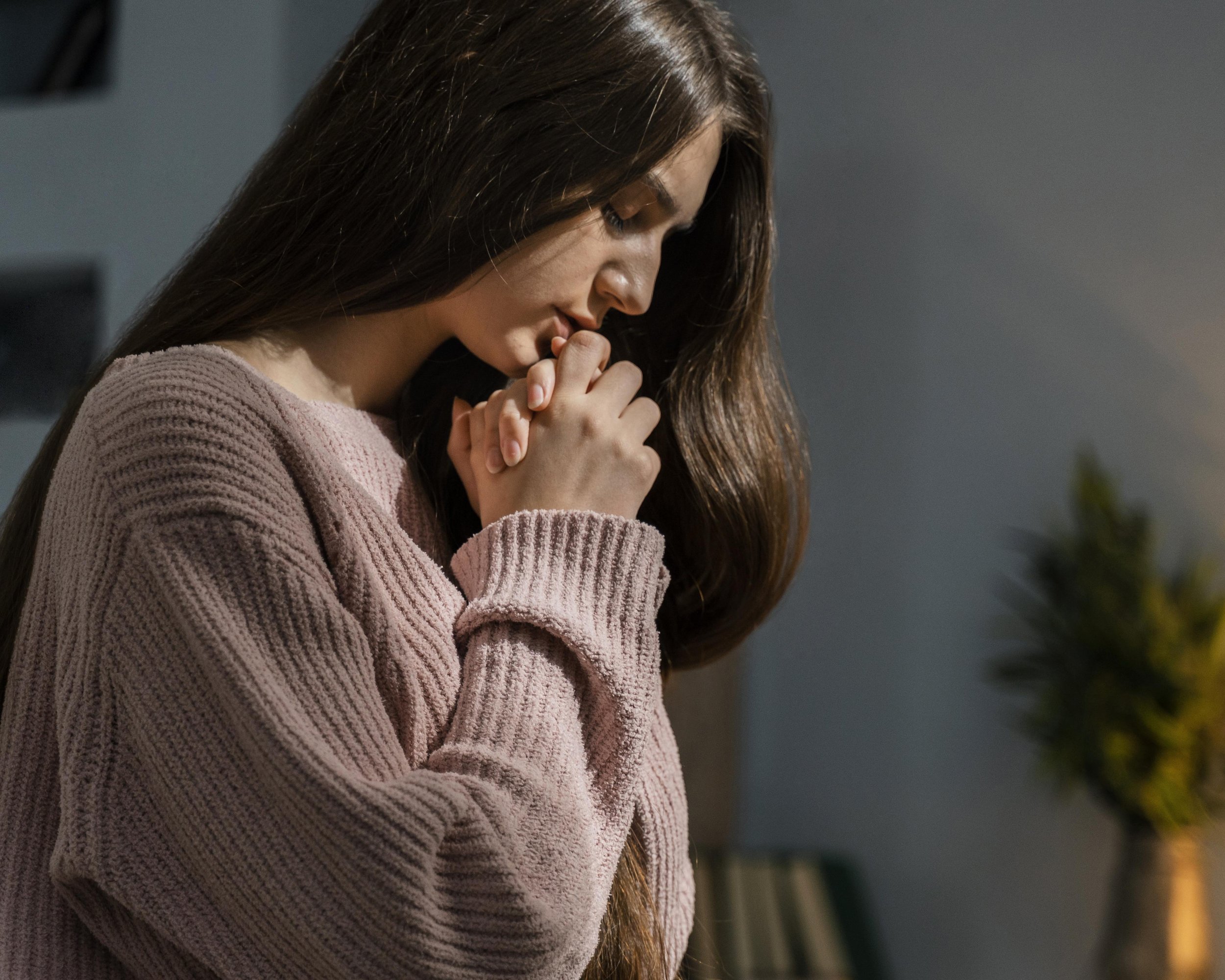 Individual reflecting on emotional struggles and considering therapy support.