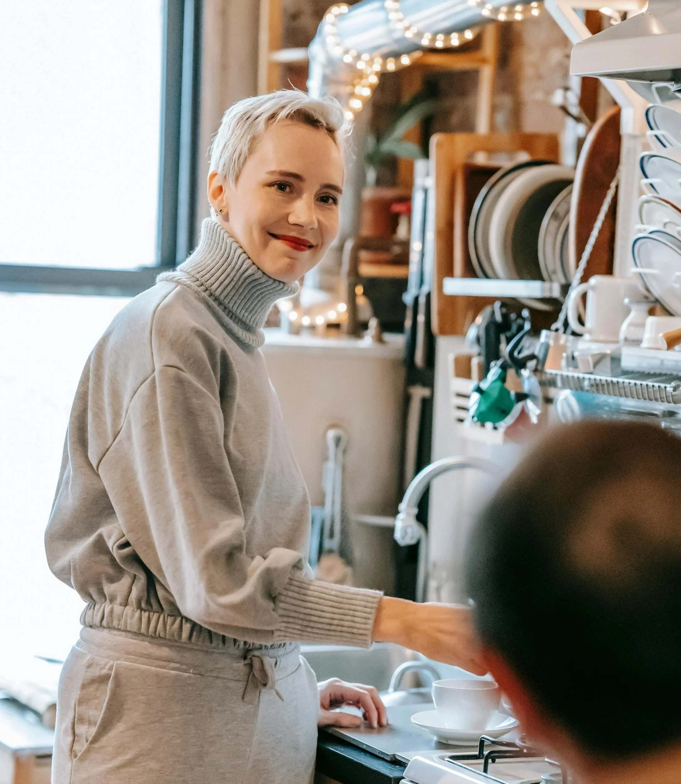 Woman managing household and work tasks while feeling emotionally drained.