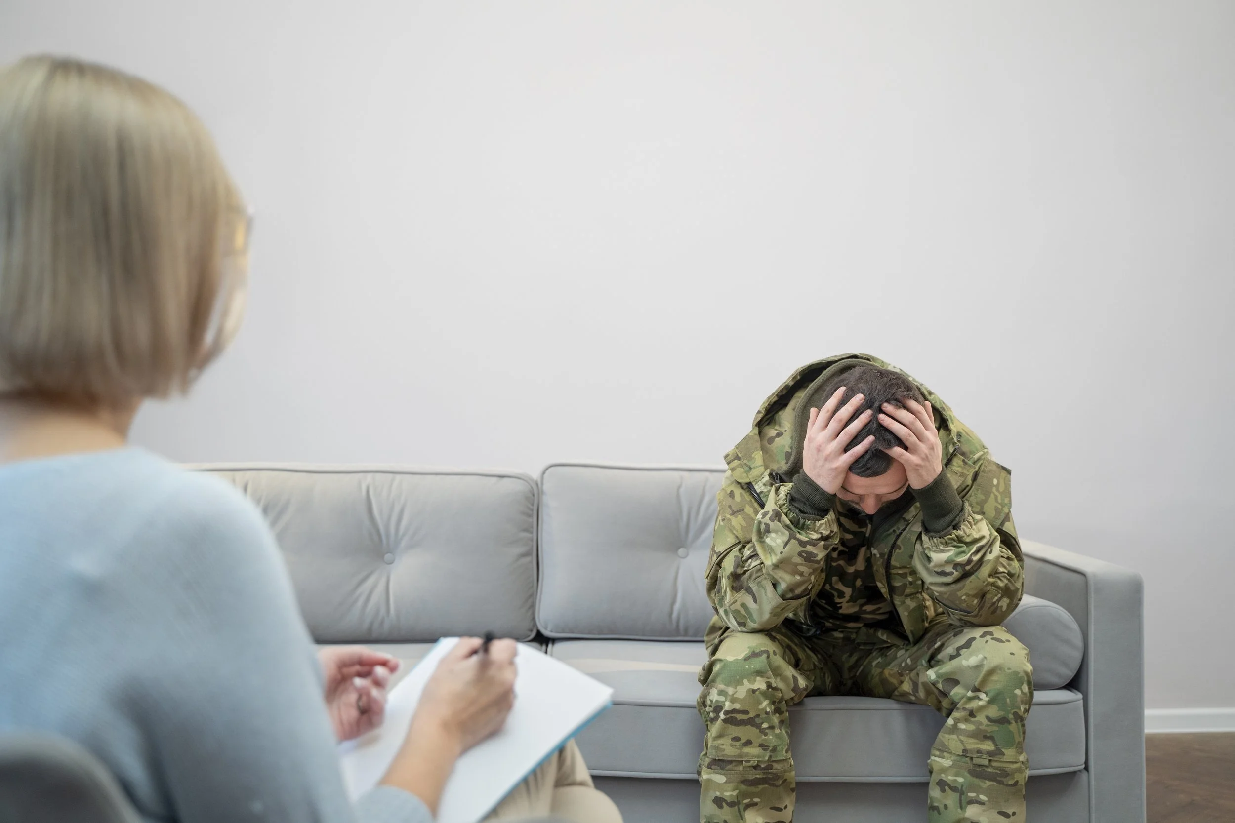 Person experiencing emotional distress and hypervigilance related to PTSD symptoms.