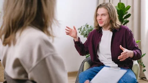 “Client discussing anxiety symptoms with therapist during counseling session.”