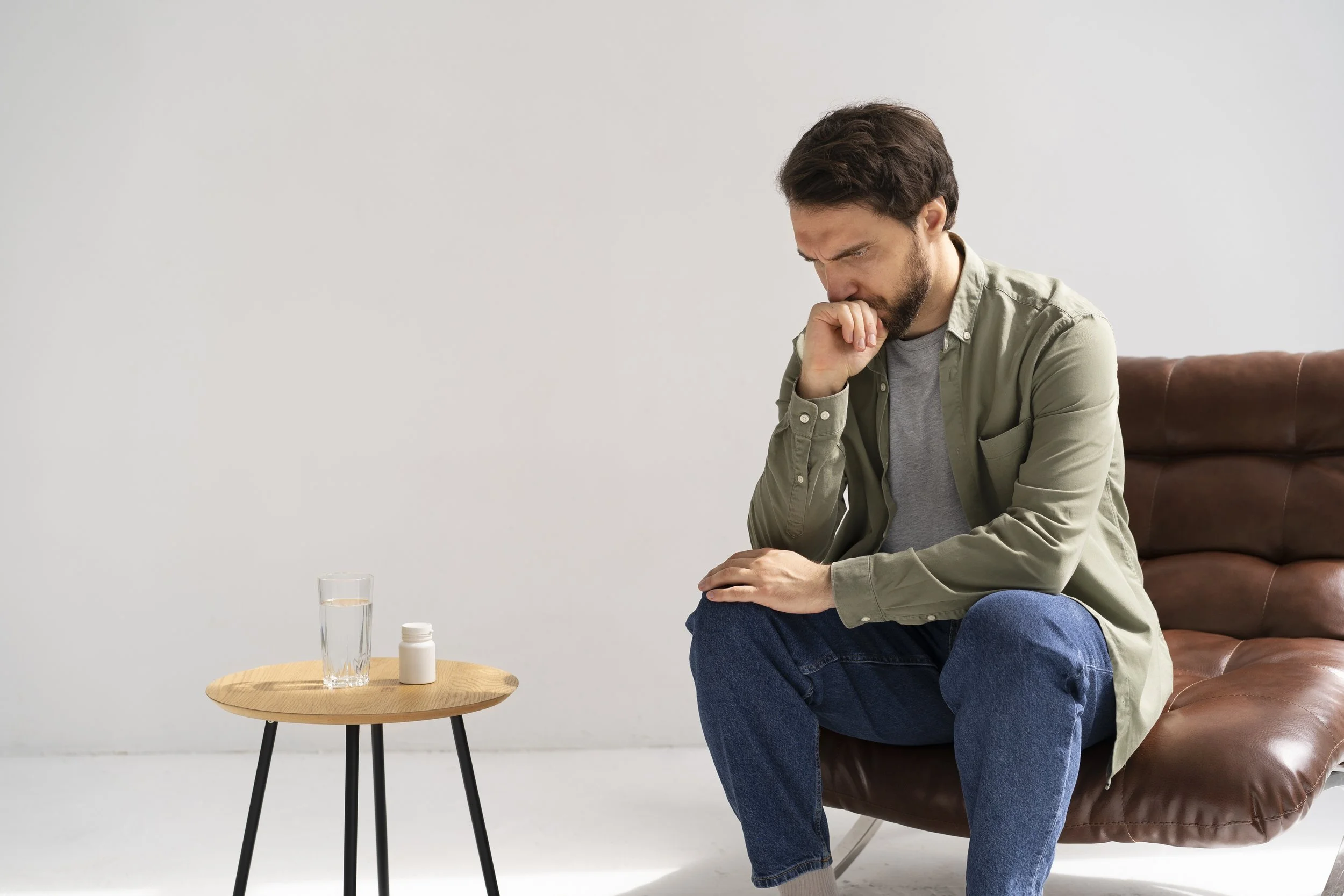 Man experiencing emotional burnout from work and life pressures.