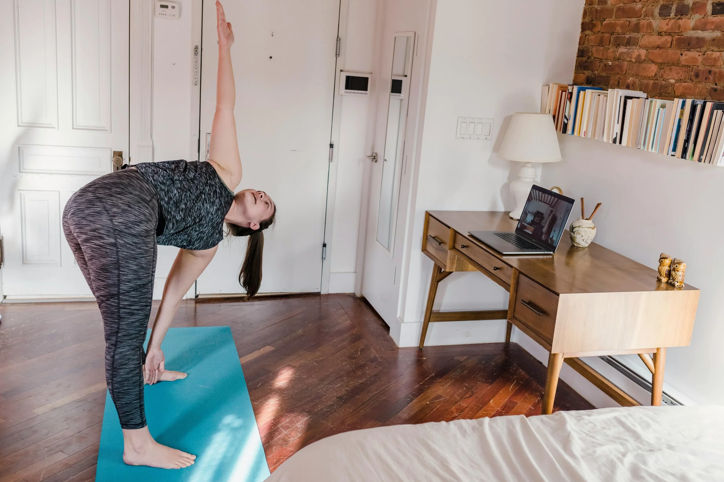 woman taking a virtual yoga class