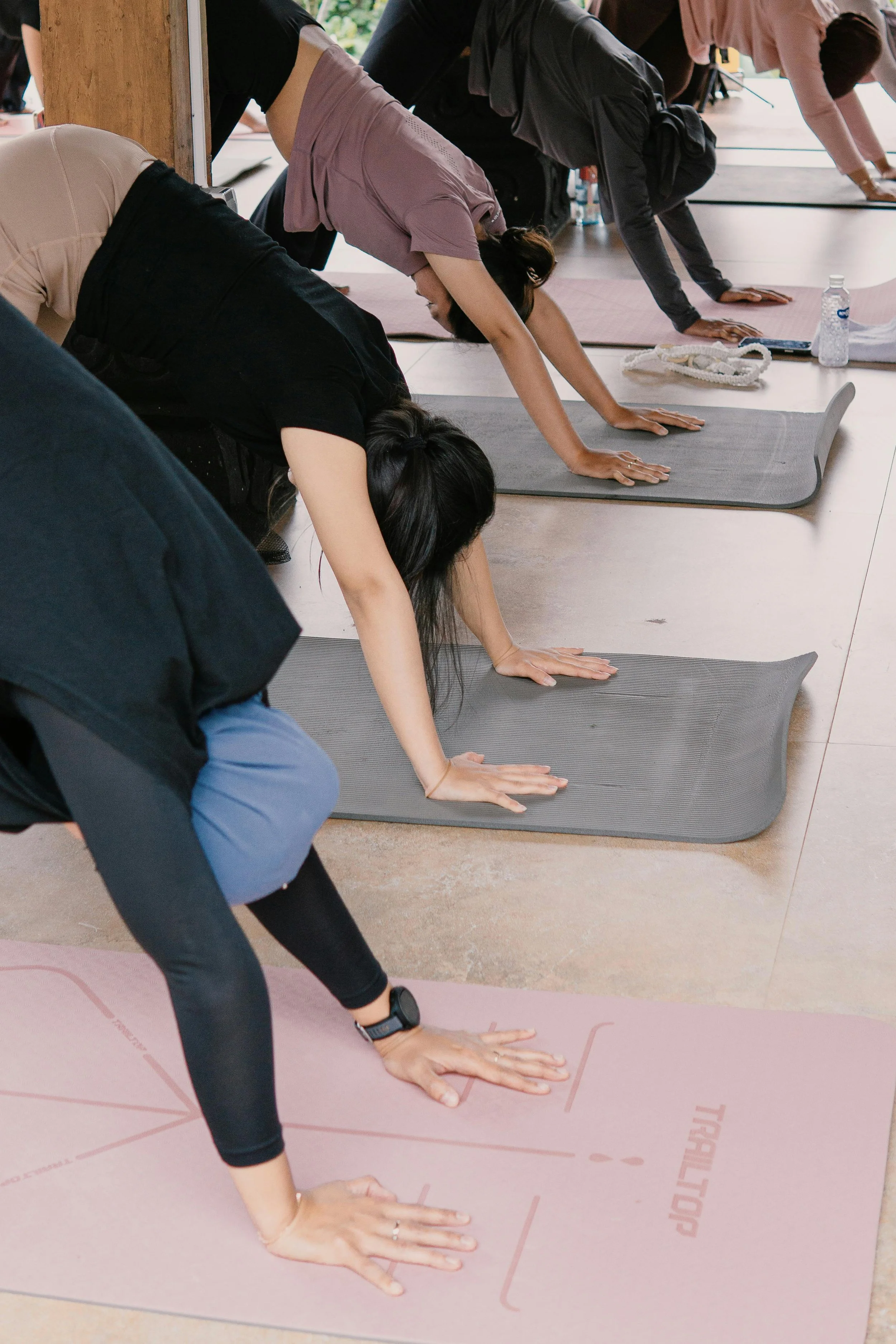 women doing downward dog in corporate yoga class