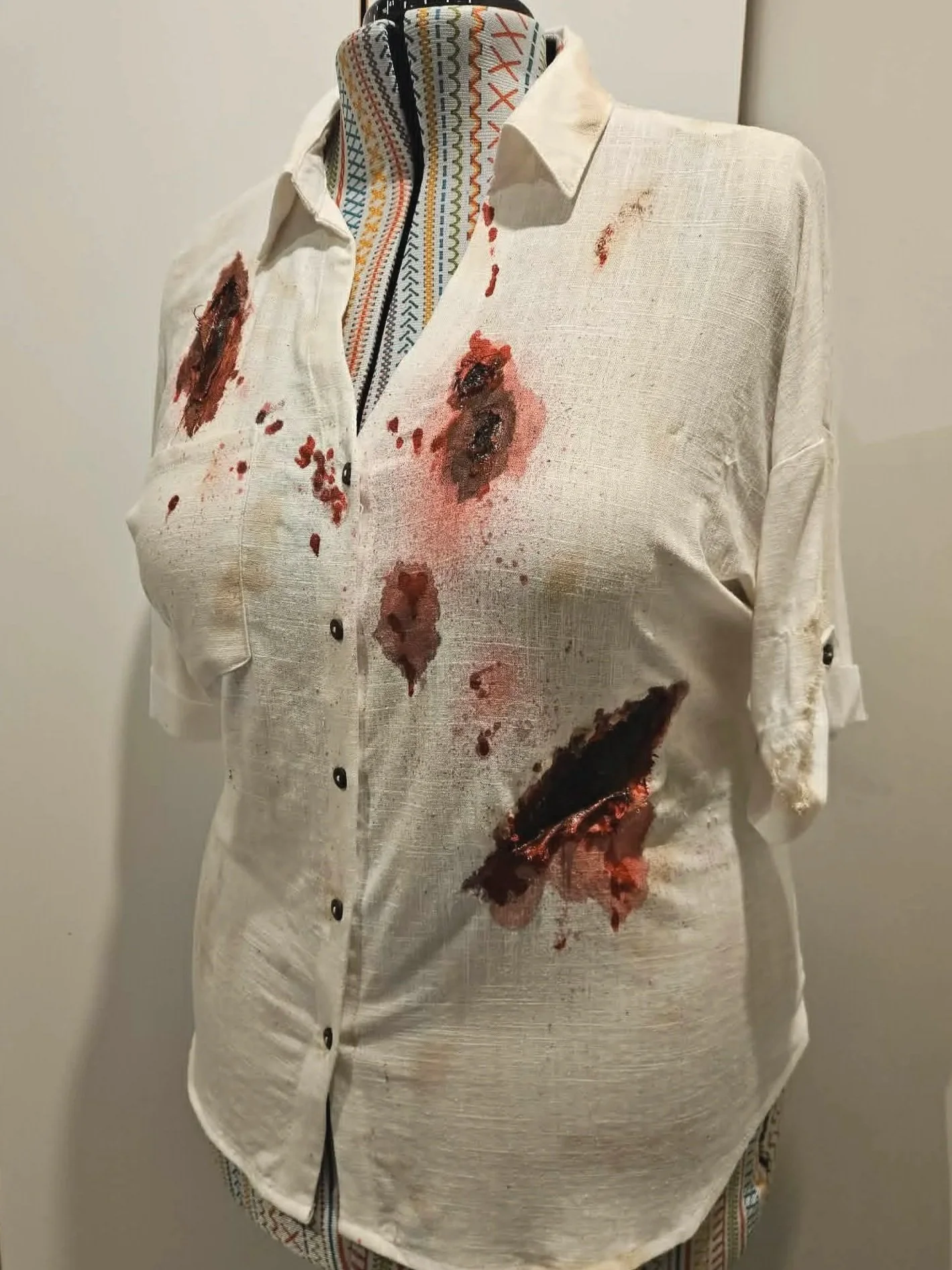 Post-stunt garment transformation, 2026. Techniques include staining, painting, texture building and layering to create a post-fight look.