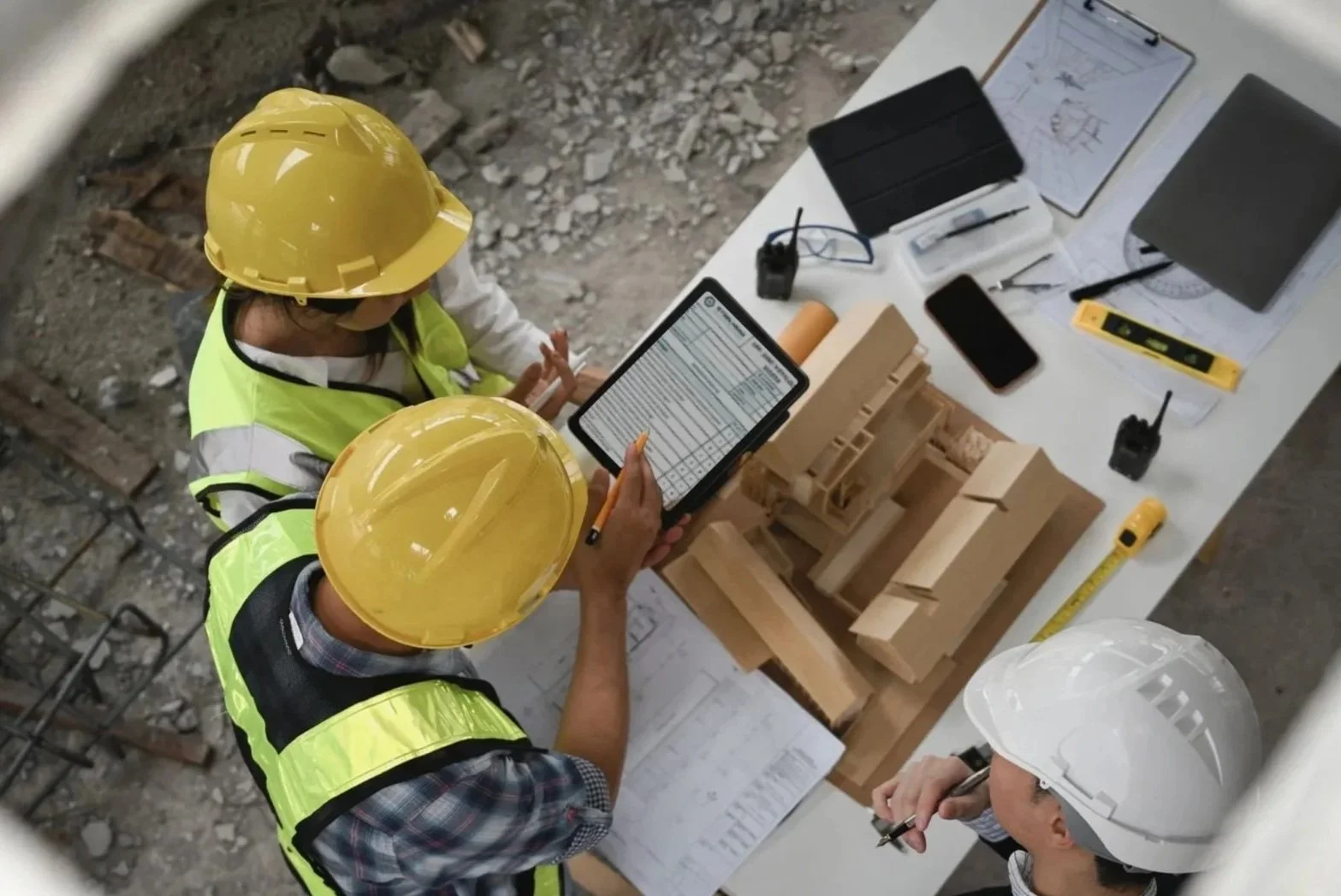 QA/QC inspectors reviewing inspection data and construction materials on-site, representing structured quality control and compliance oversight.