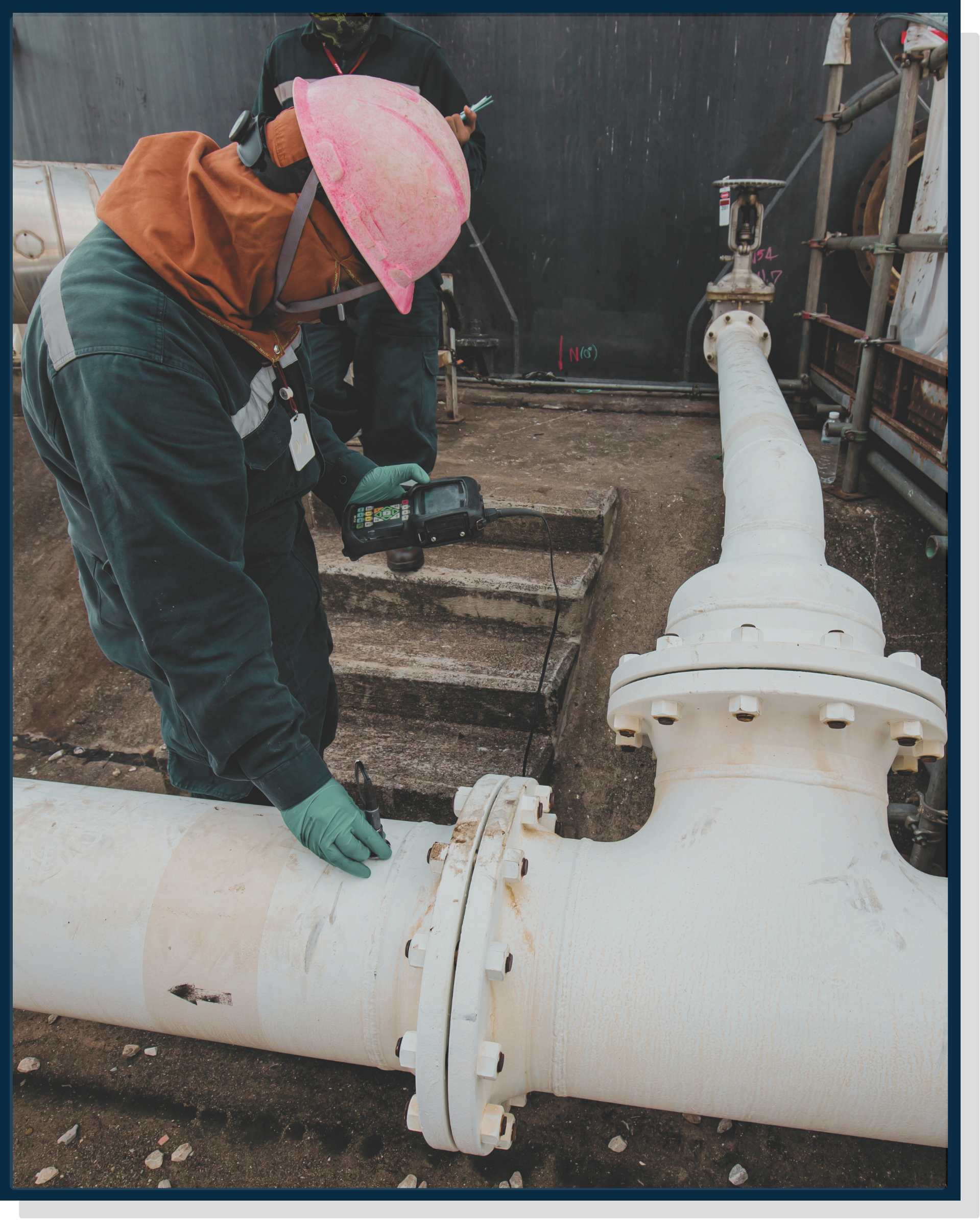 Technician inspecting pipeline and valve assembly, representing disciplined asset integrity inspection and maintenance planning.