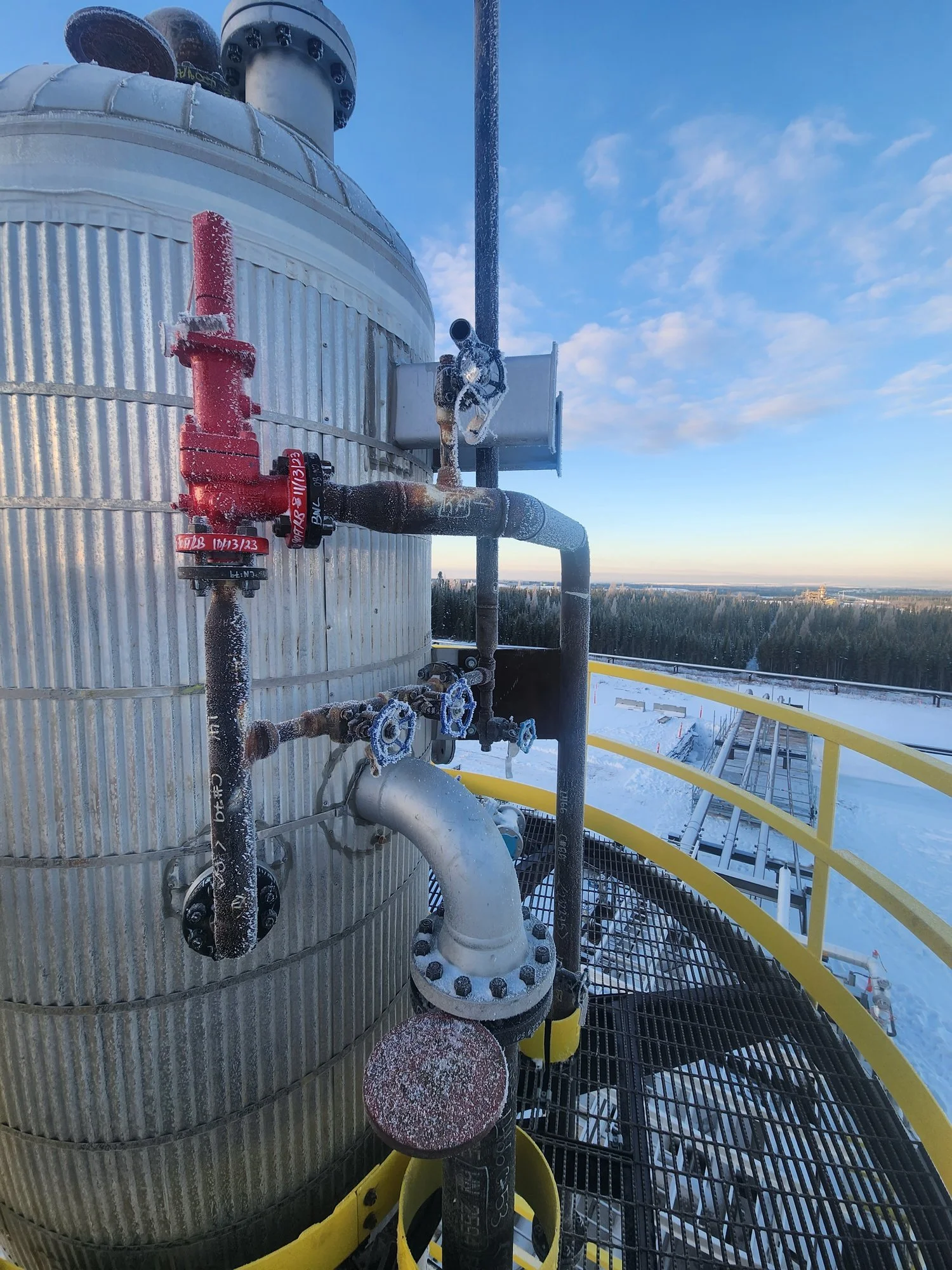 Industrial storage tank with connected piping, valves, and instrumentation, showing asset integrity and inspection considerations at an operating facility.