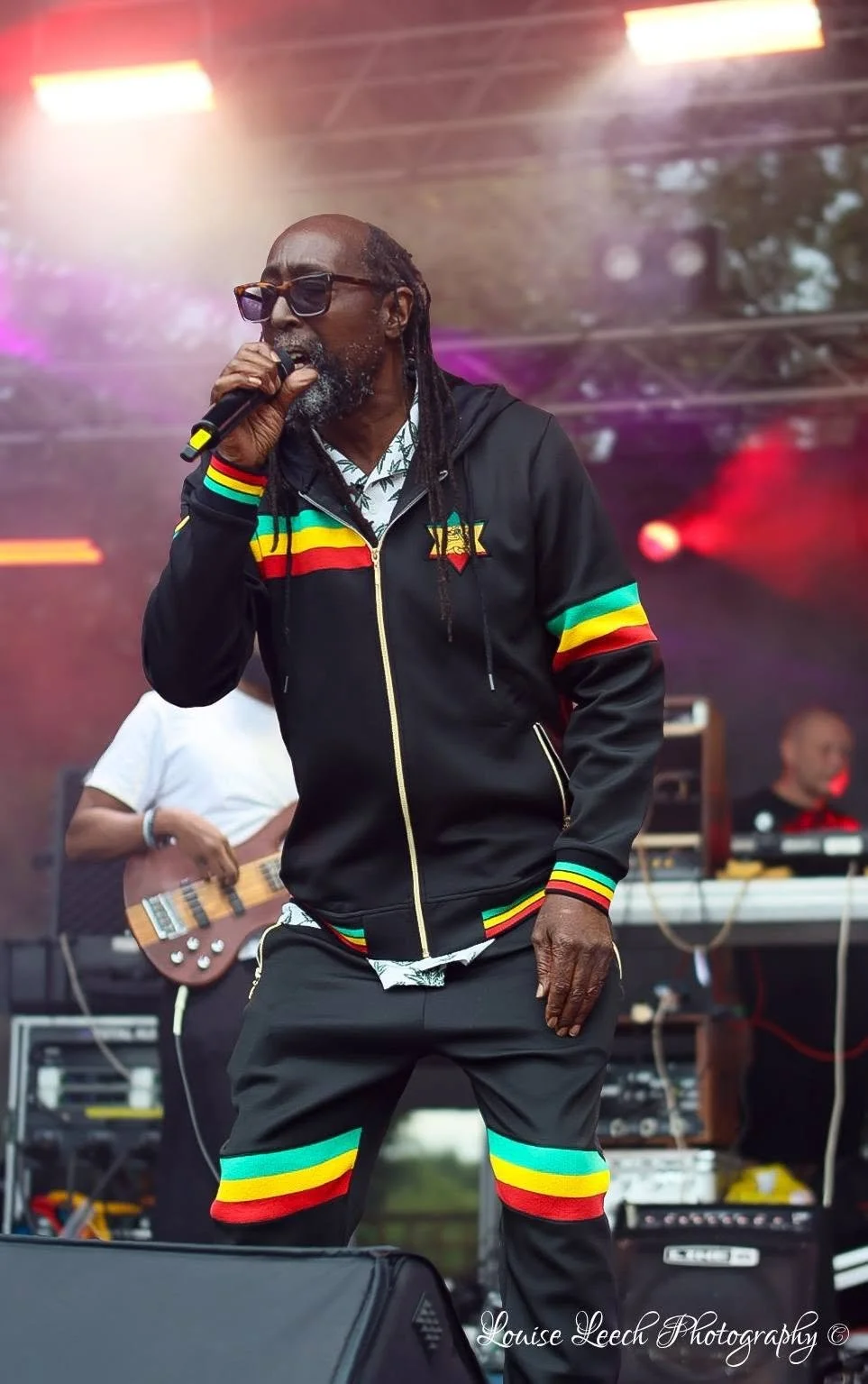 Image of Island Collective performing on stage, showing lead singer, Sensi.