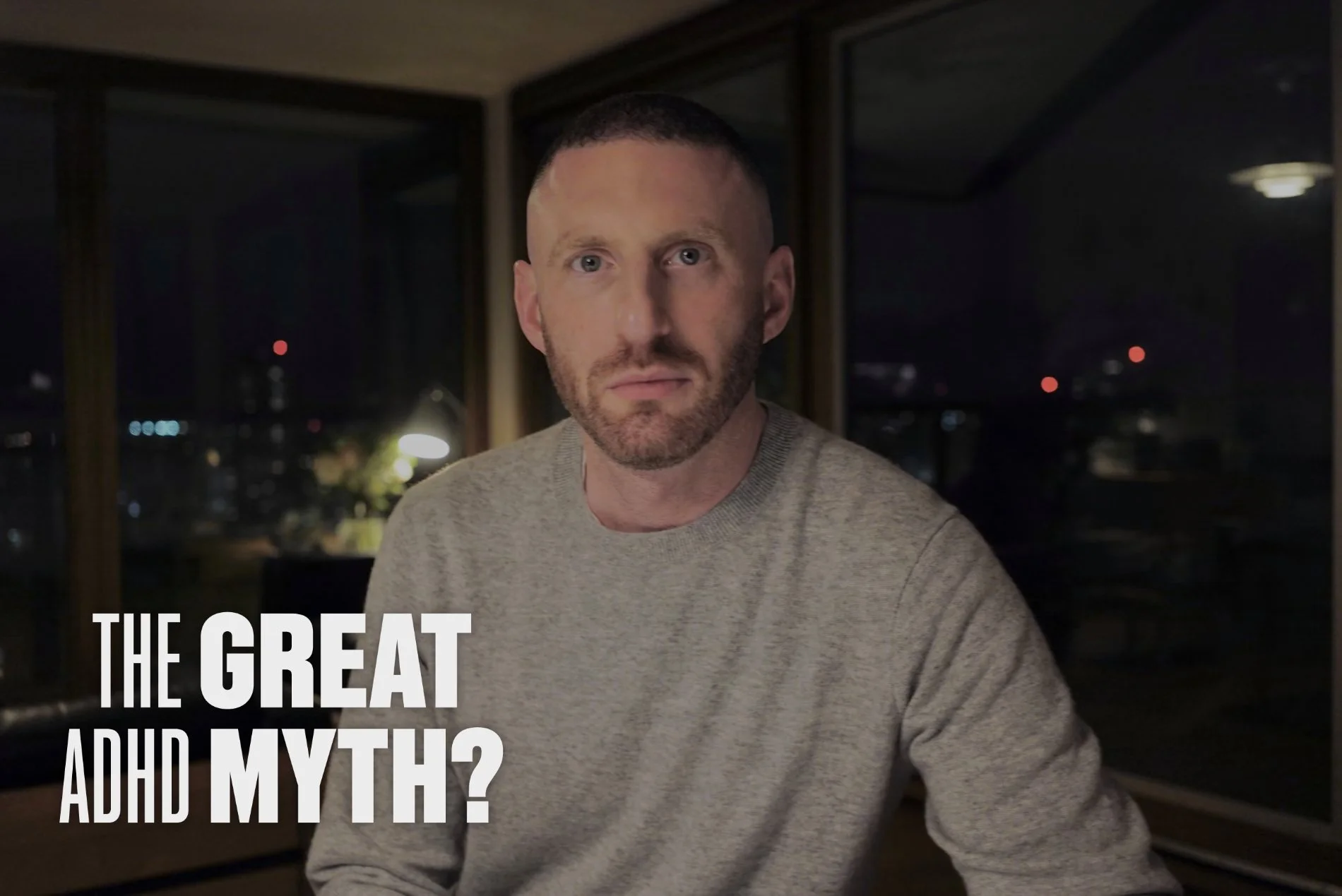 A still from the Channel 4 documentary "The Great ADHD Myth?" showing documentarian Max Pemberton looking straight into the camera with a neutral, pensive expression, against a backdrop of a cityscape at night.