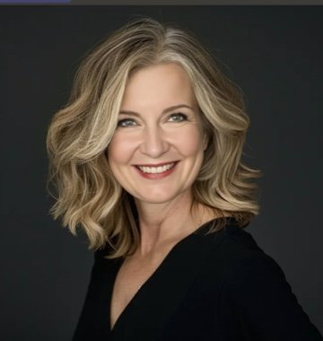 Smiling woman with shoulder-length blonde hair wearing a black top against a dark background.