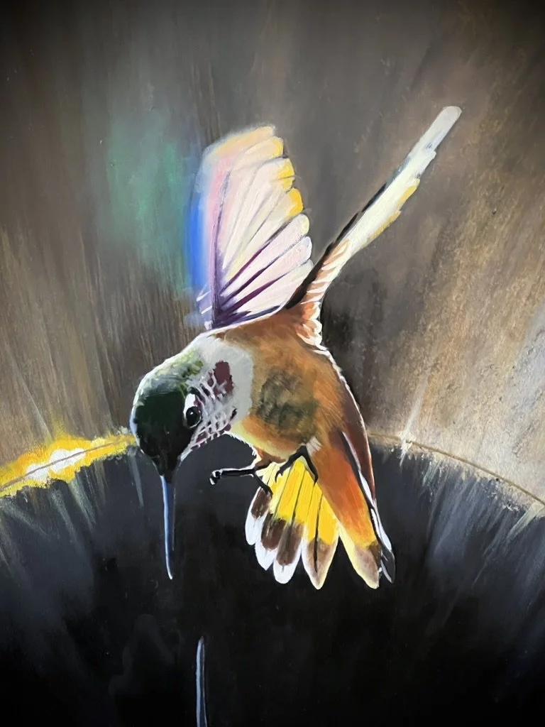 Painting of a hummingbird with iridescent wings hovering in front of a glowing solar eclipse.