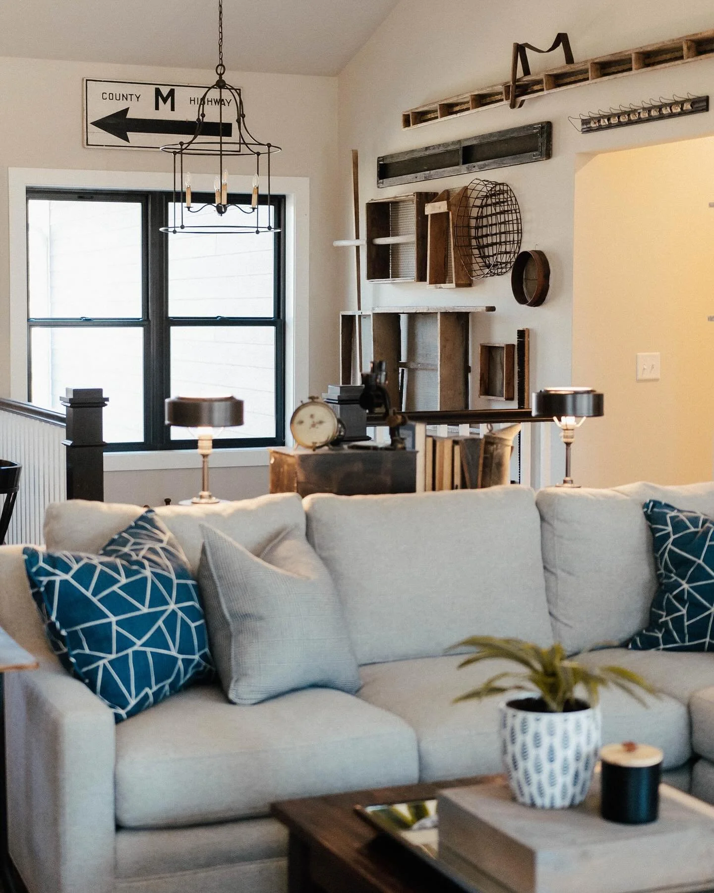 This living space is all about character! From the vintage decor pieces on the wall to the modern comfort of the sofa, we love how this room tells a story. The rich textures and eclectic mix create a cozy, inviting vibe perfect for relaxing or entert