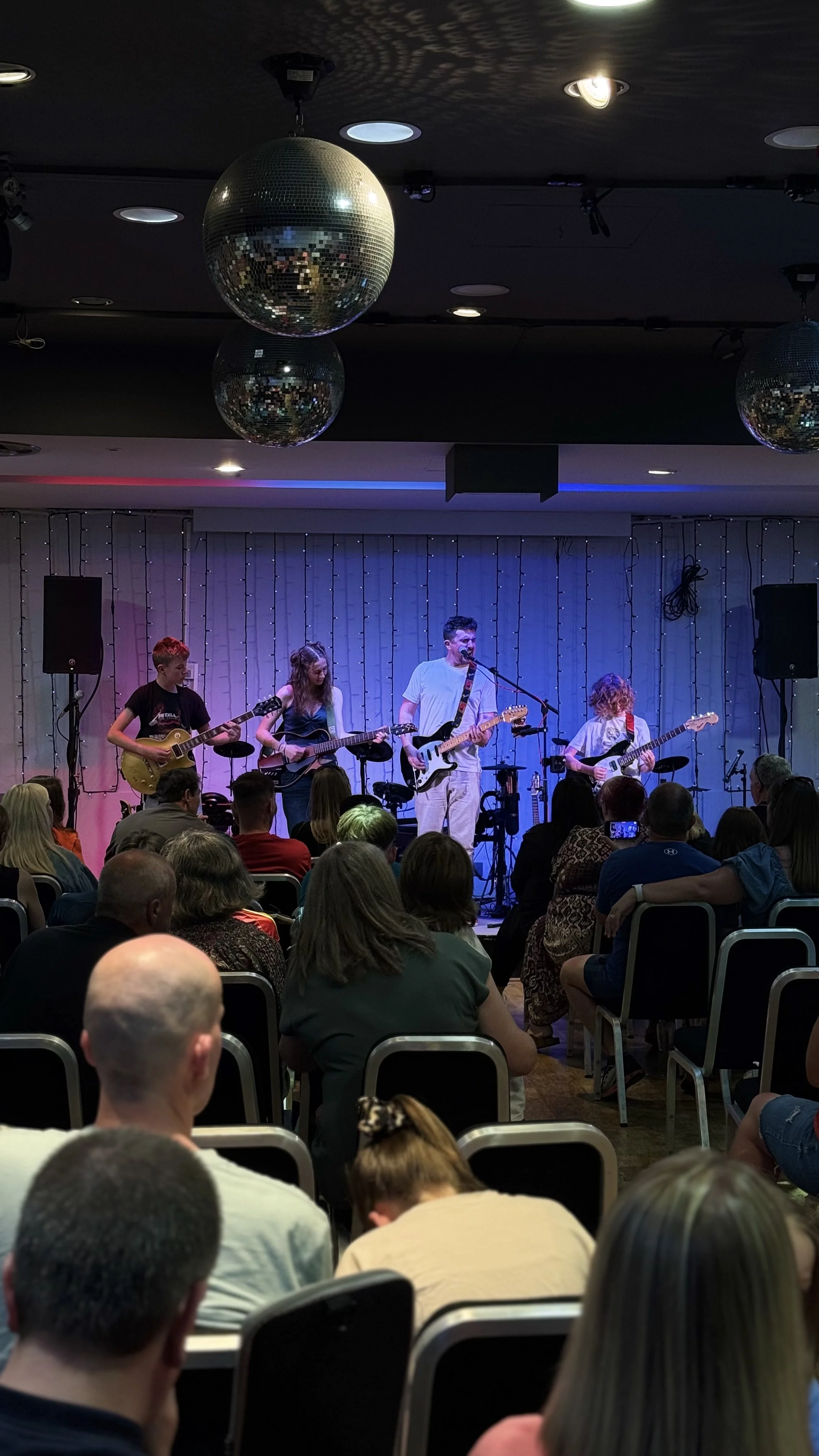 Students performing in a band at One Lad Music Academy showcase event, Westhill
