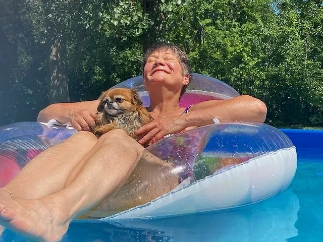 woman and dog in pool
