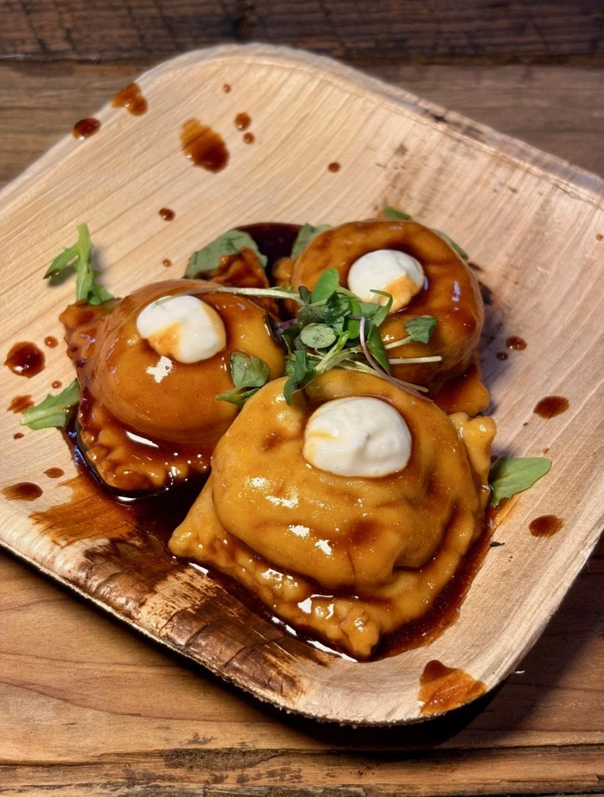 homemade ravioli with micro greens and white sauce