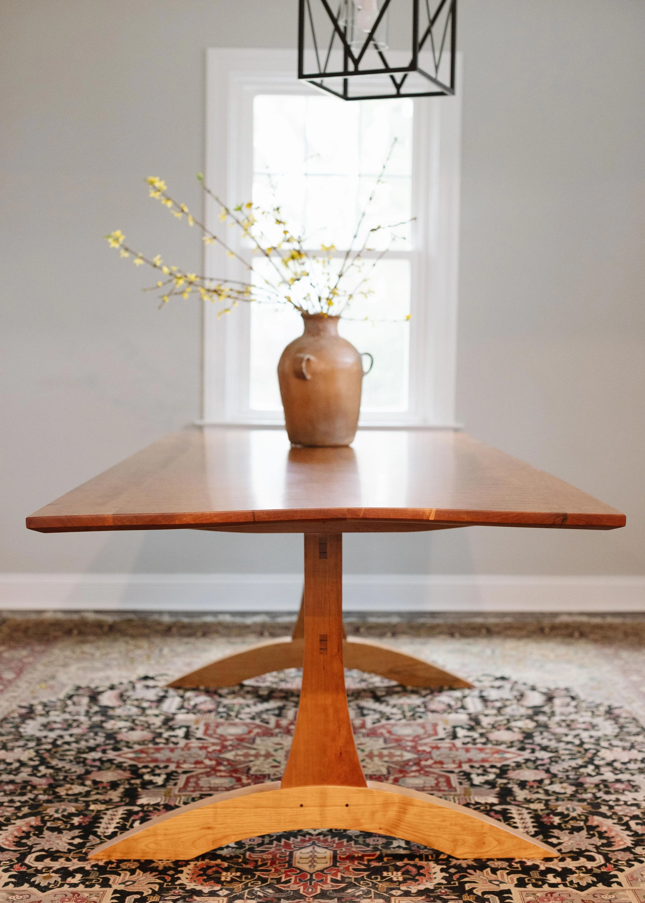 Solid Cherry Dining Table with through joinery and curved stretcher