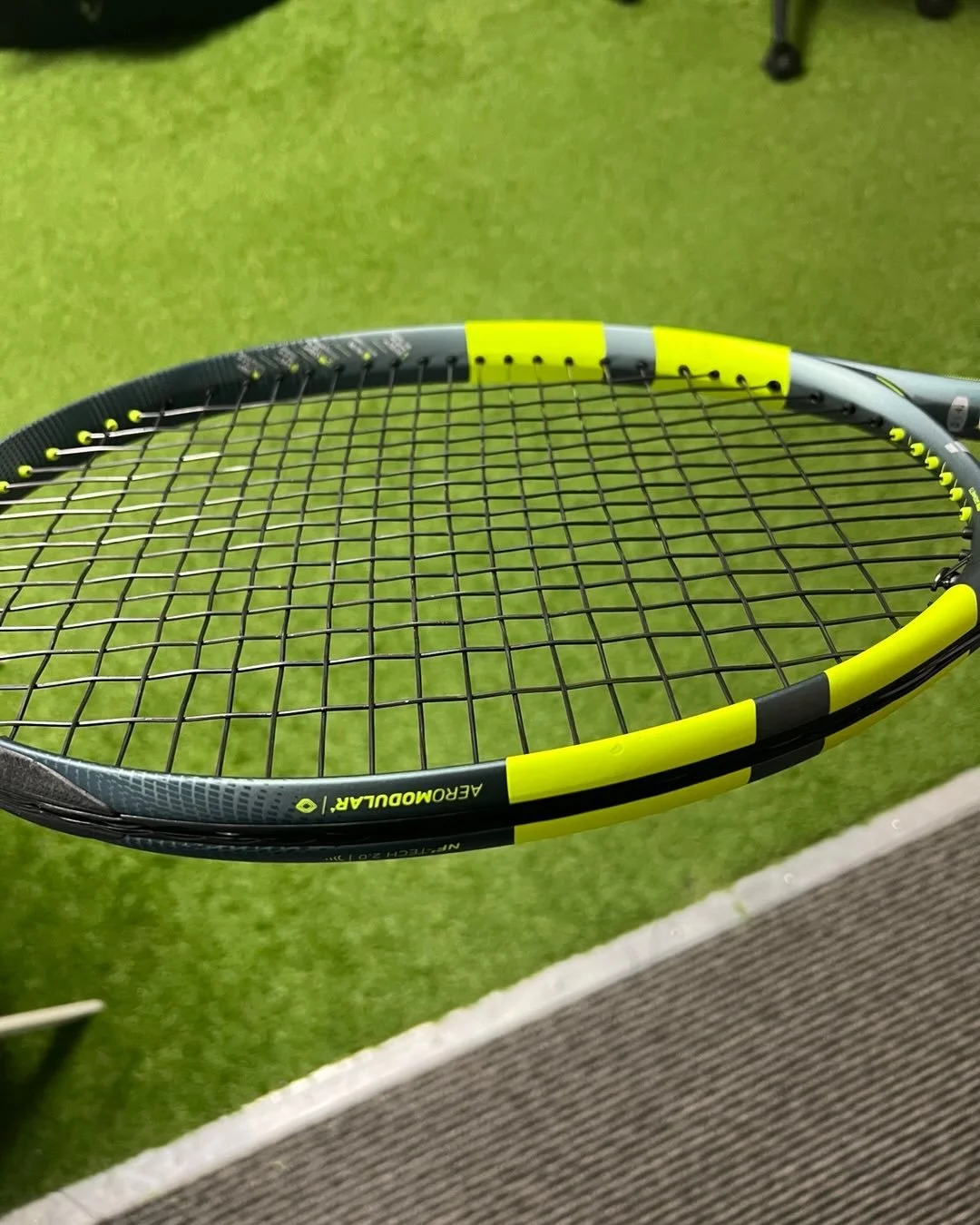 Careful who you let string your racquets. This racquet ass strung as a one piece bottom to top. Knots are crazy loose, and strings are smiley faced and not straight at all.