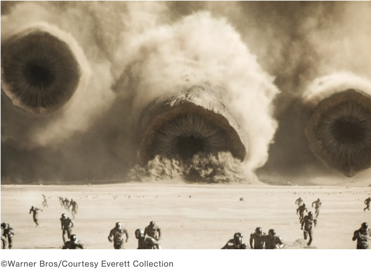 Three sandworms from Dune Part 2 emerge from a sandstorm in the climactic battle.