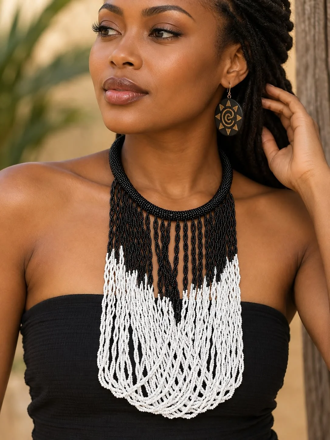 Black and white beaded necklace on charcoal model.jpeg