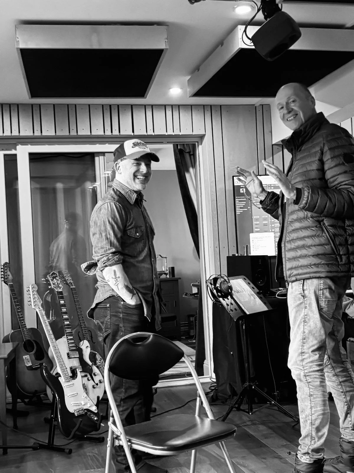 two happy looking men one older one younger happily enjoying a fancy studio