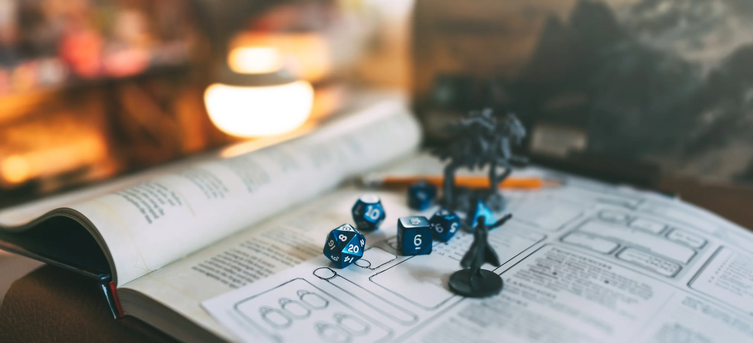 Tabletop gaming setup with open rulebook, blue polyhedral dice, and miniature figures of soldiers or adventurers, with warm background lighting.