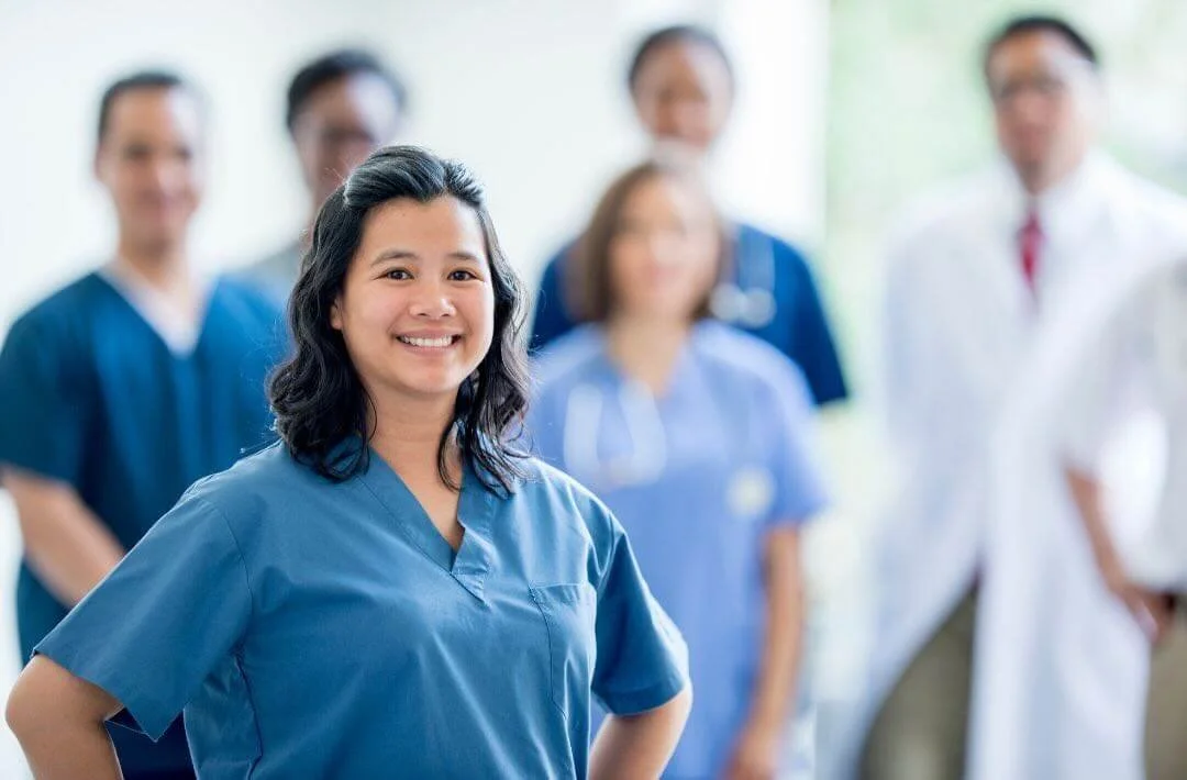 A Filipino nurse standing confidently.
