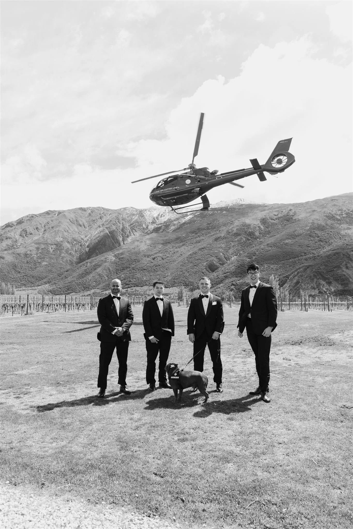 Young girl in a white dress standing in oversized heels, looking down.