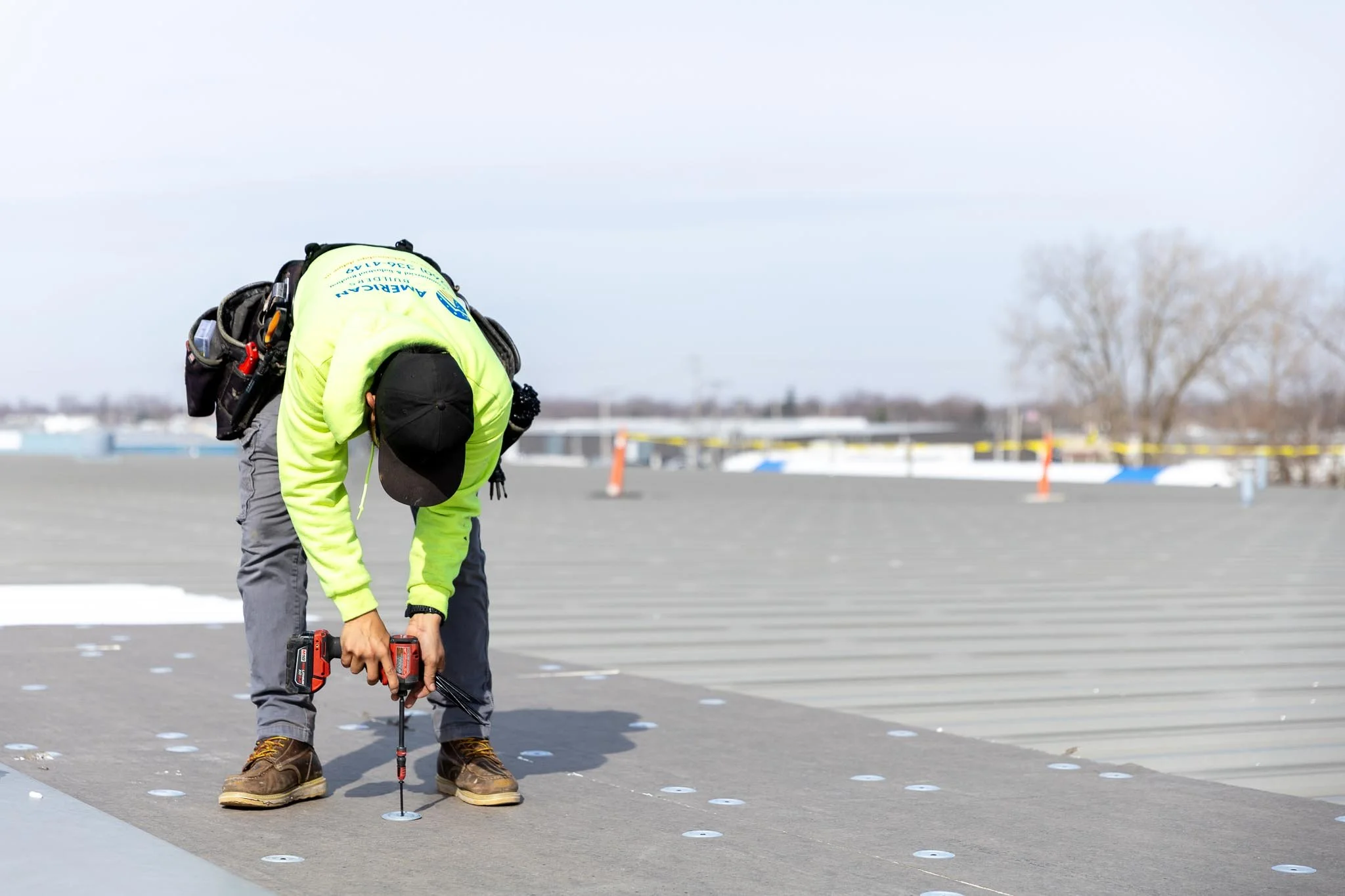 An American Builders commercial roofer making repairs on a commercial roof in Northern Indiana