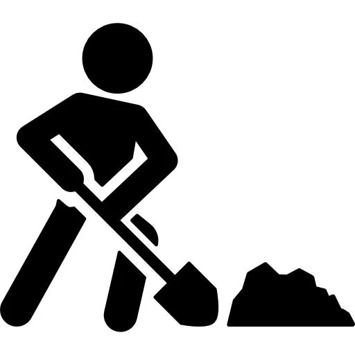 En silhuett av en person som gräver i marken med en spade.